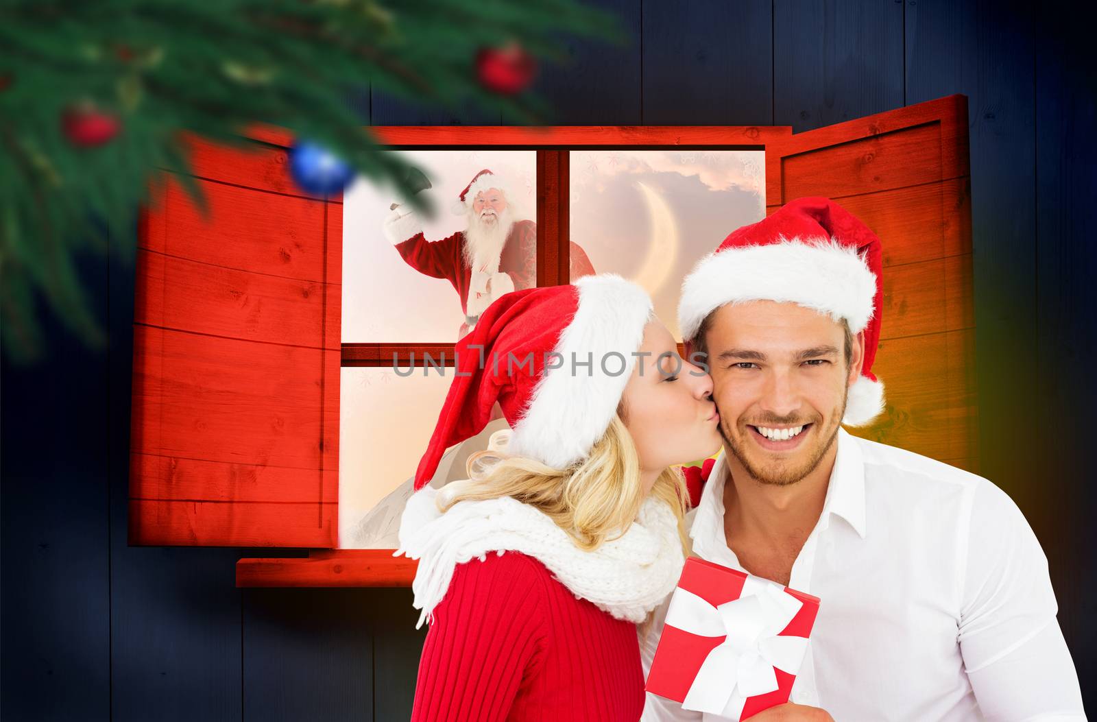 Young festive couple against festive fir branch with baubles 