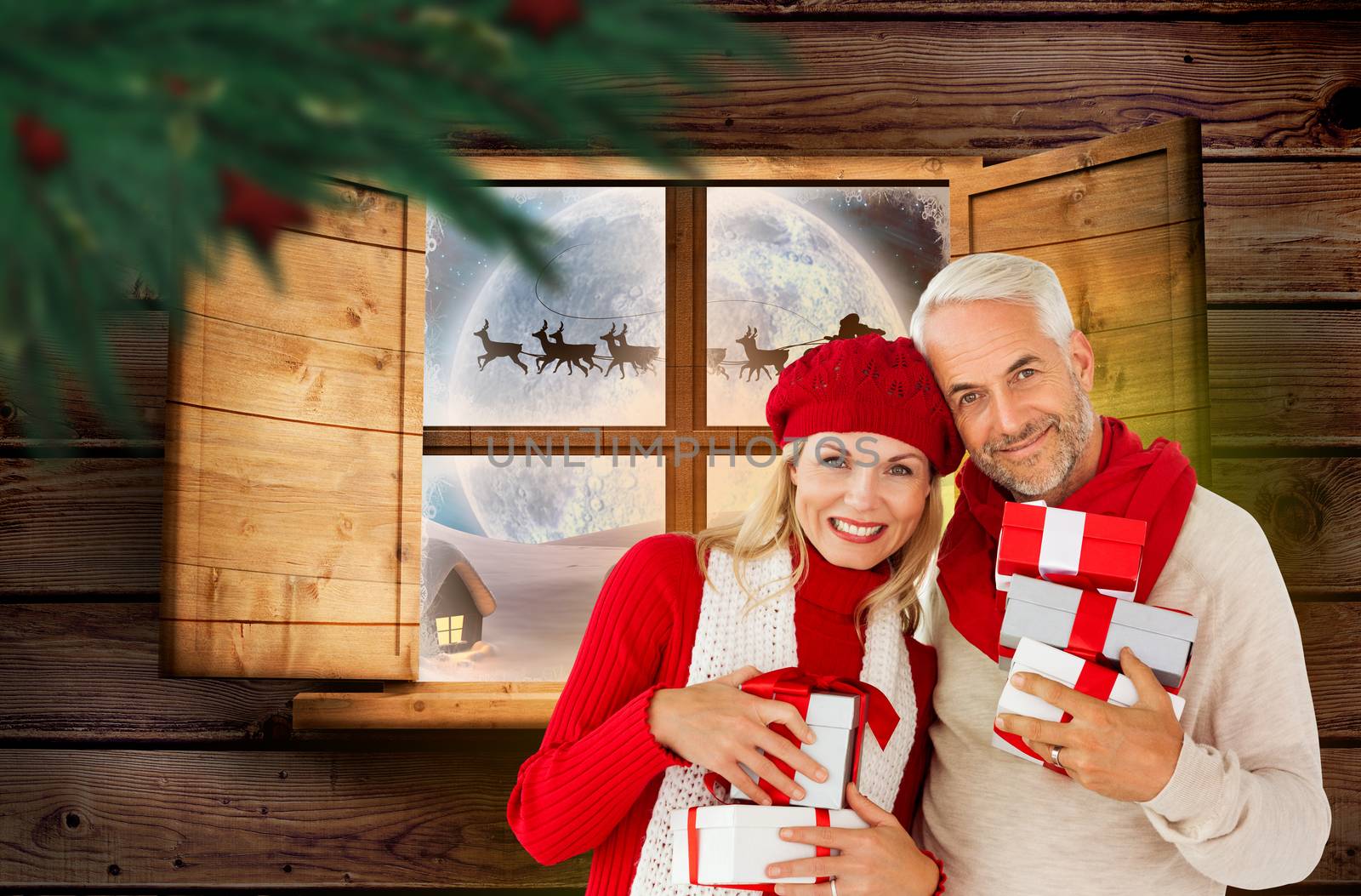 Composite image of happy festive couple with gifts by Wavebreakmedia