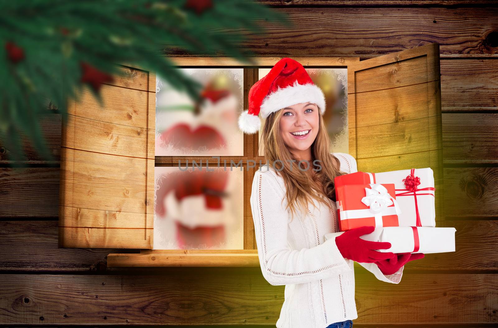 Composite image of festive blonde holding pile of gifts by Wavebreakmedia