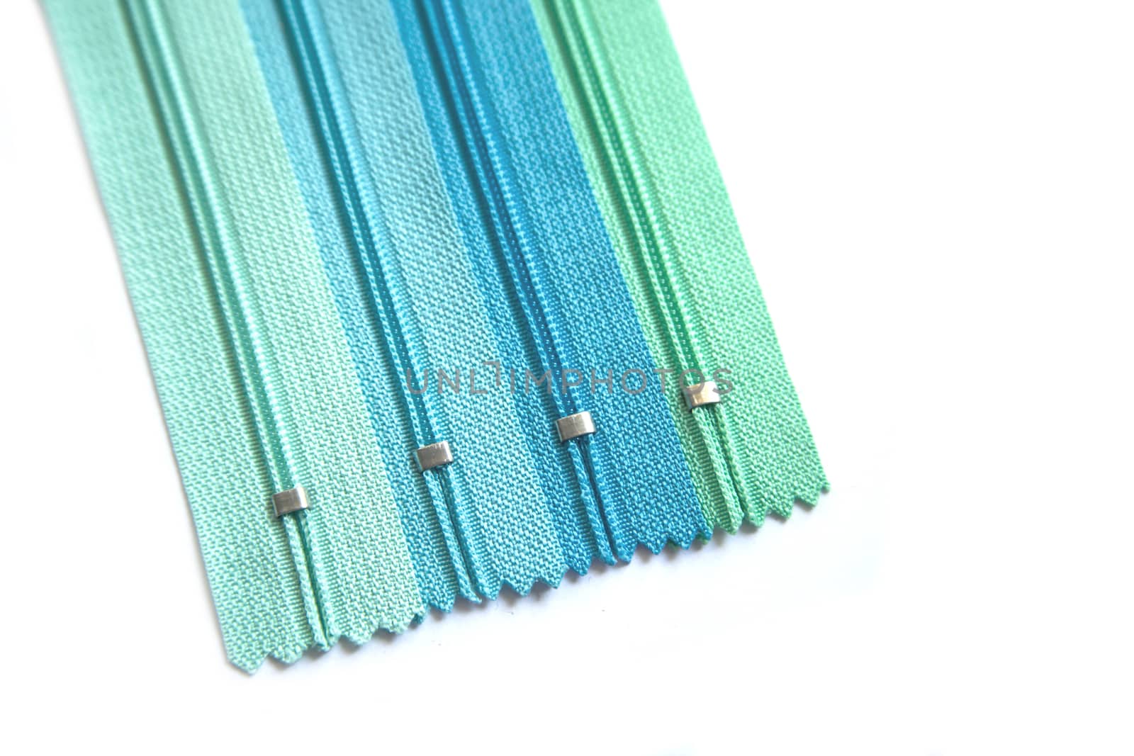 Clothing zipper end pastel green and blue set isolated on white background