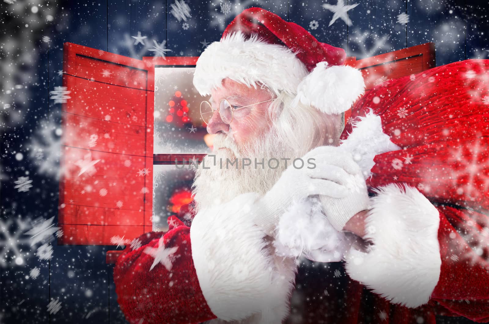 Santa claus carrying sack against christmas at home 