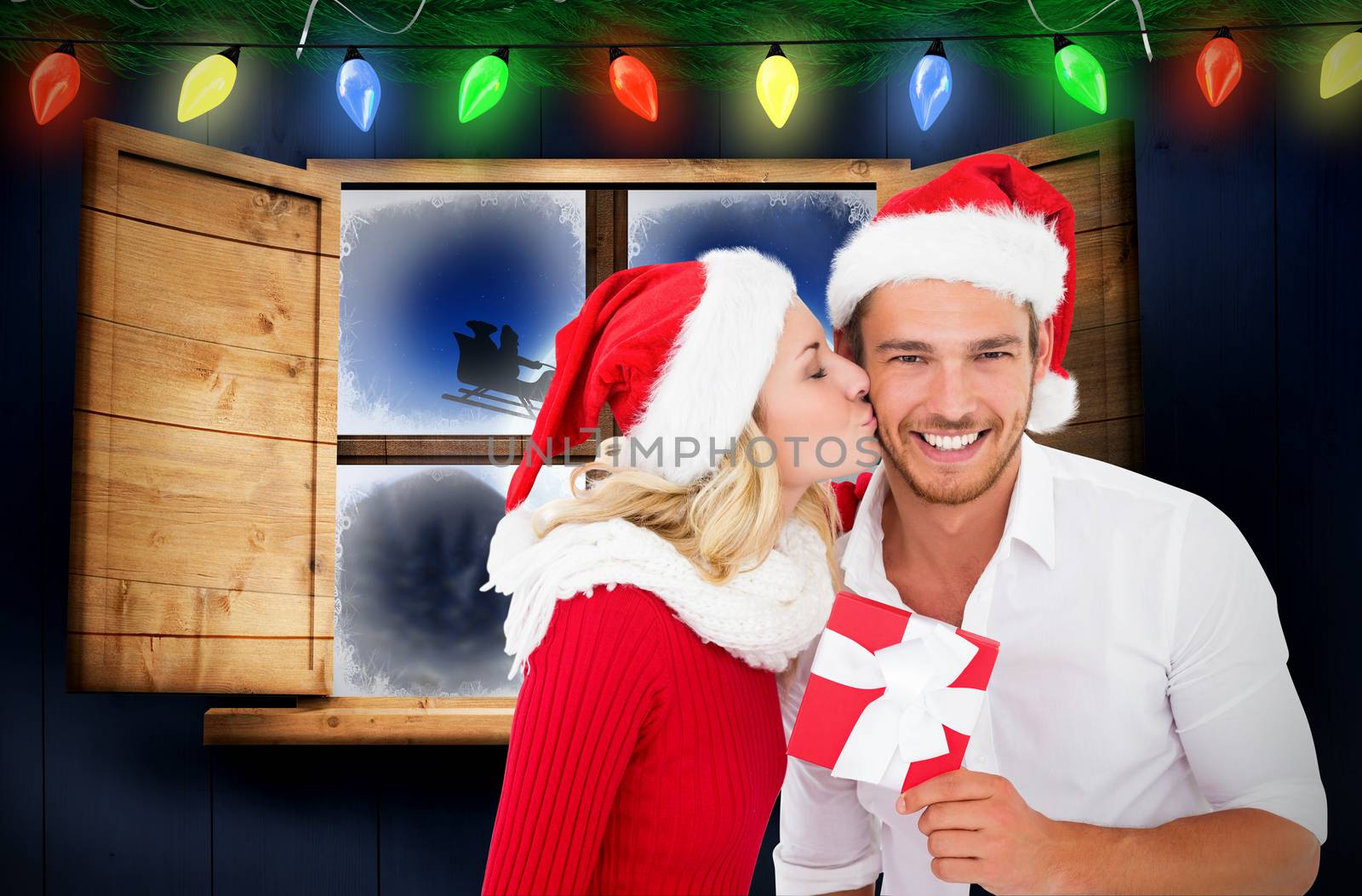 Young festive couple against santa delivery presents to village