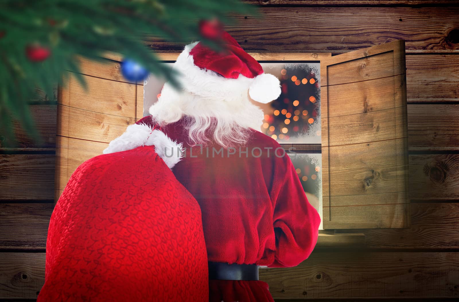Composite image of santa claus carrying sack by Wavebreakmedia