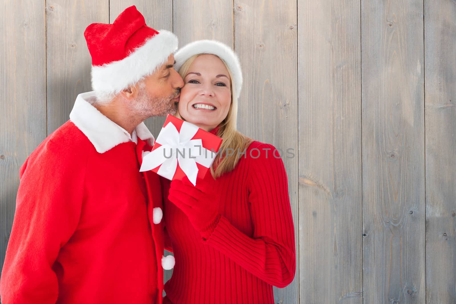 Composite image of festive couple by Wavebreakmedia