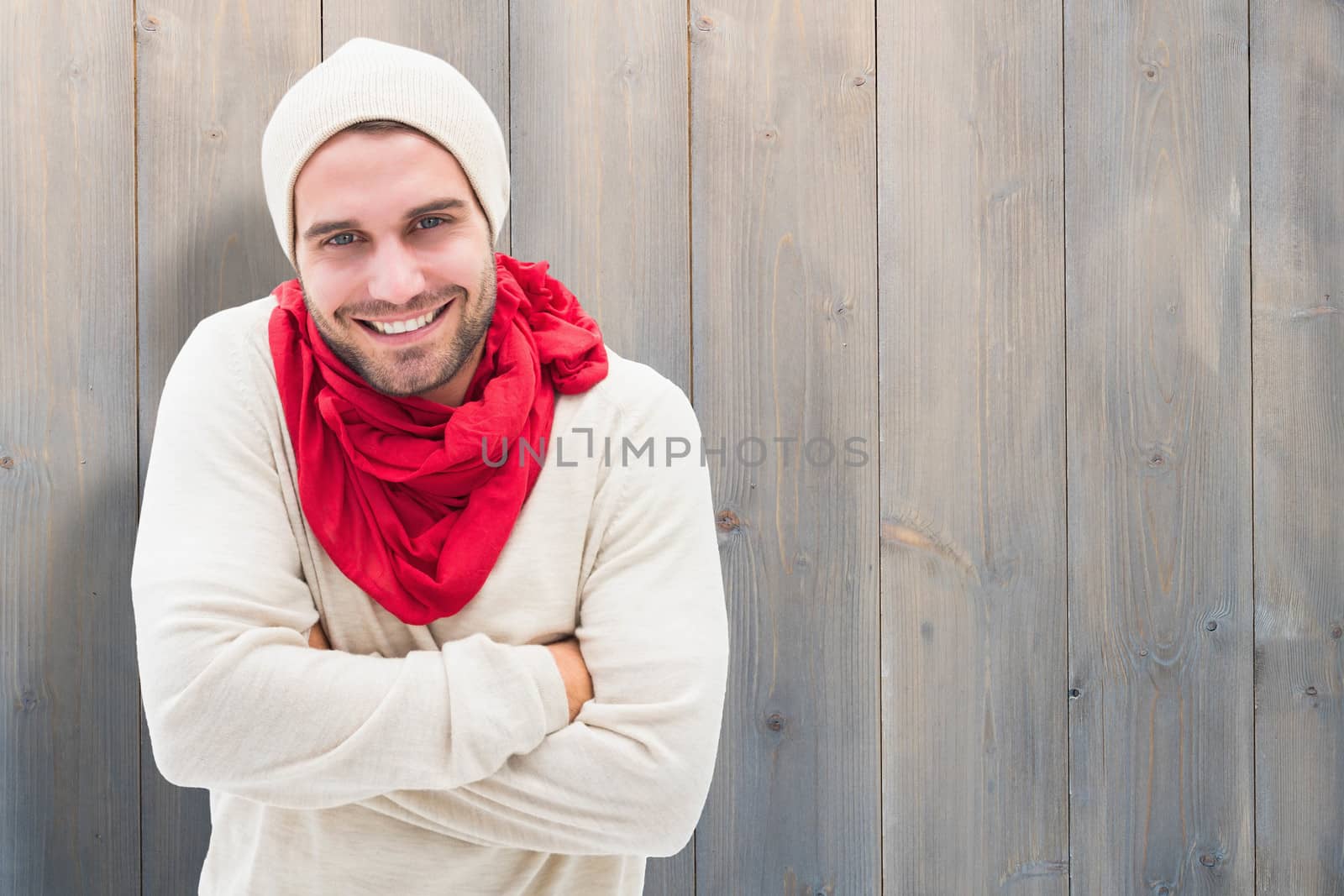 Handsome hipster against pale grey wooden planks