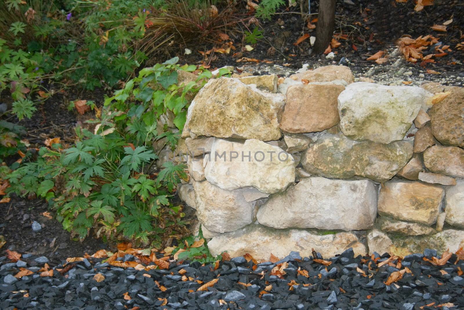 The portion of a dry stone wall in the ornamental garden 