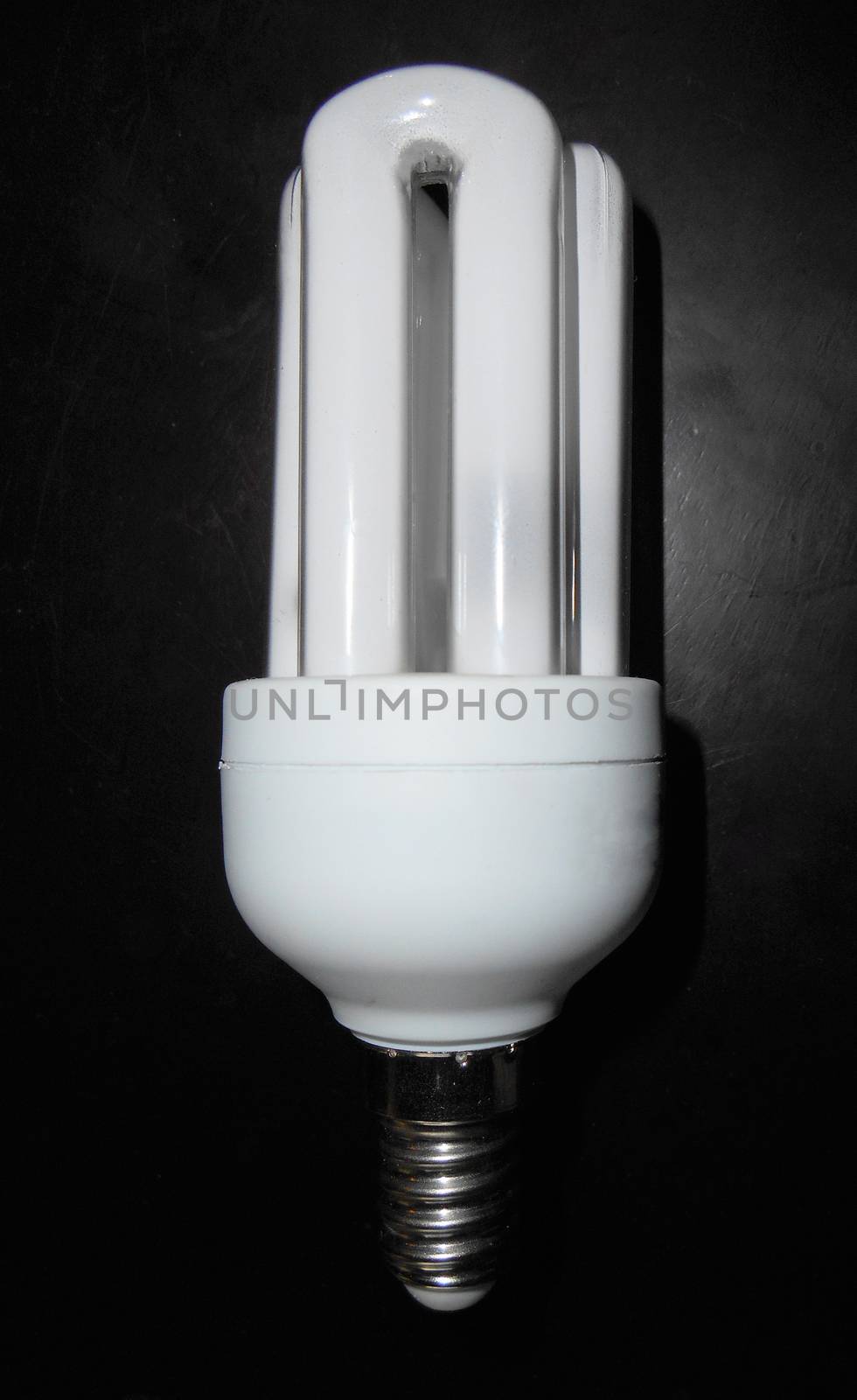 Compact fluorescent lightbulb on wooden table by ValEs1989