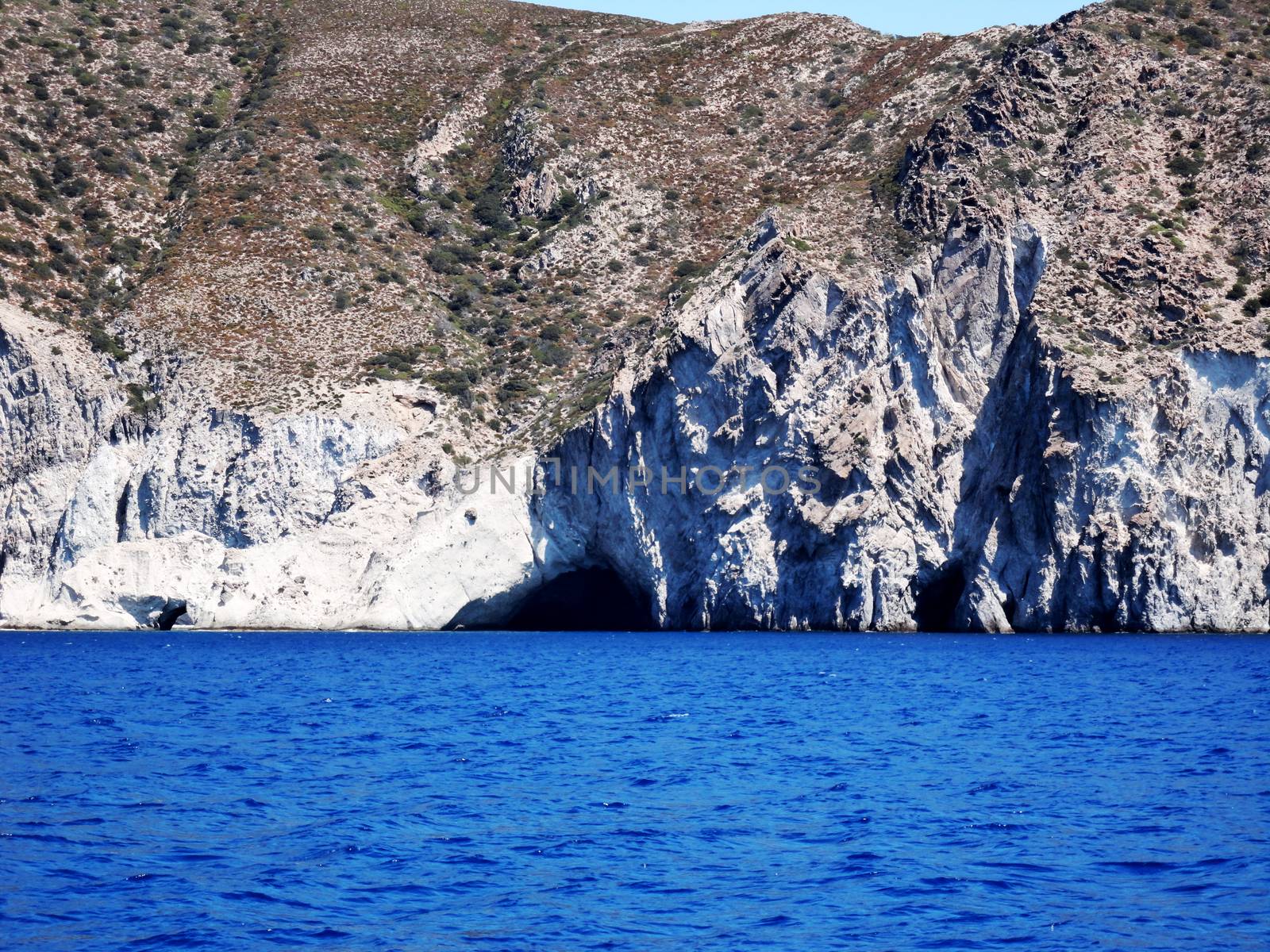 Distant view of a Small cave and crystal clear waters of Paros Island, Greece.

Picture taken on September 1, 2011.