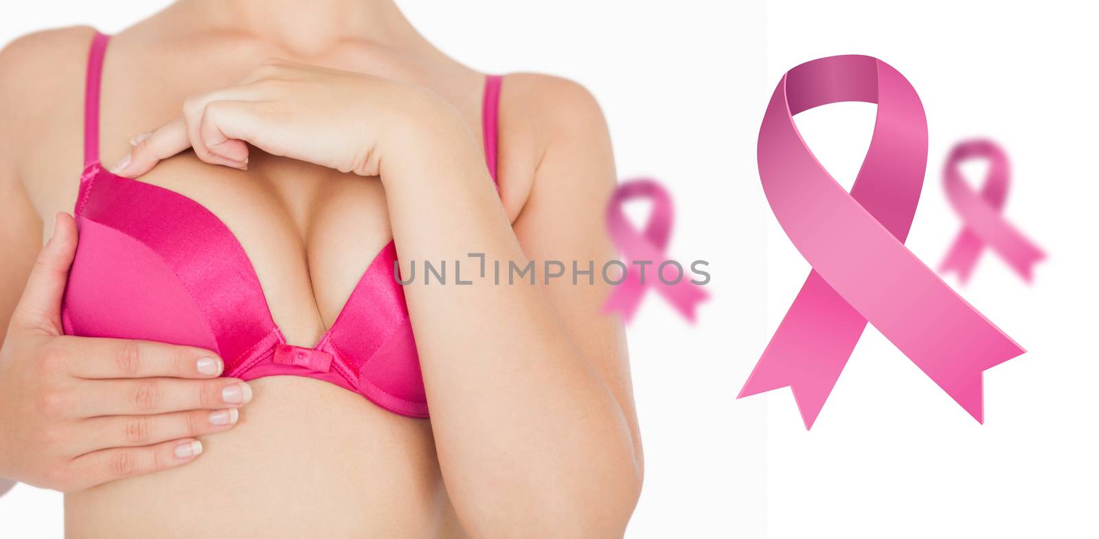 Closeup of woman performing self breast examination against pink breast cancer awareness ribbons