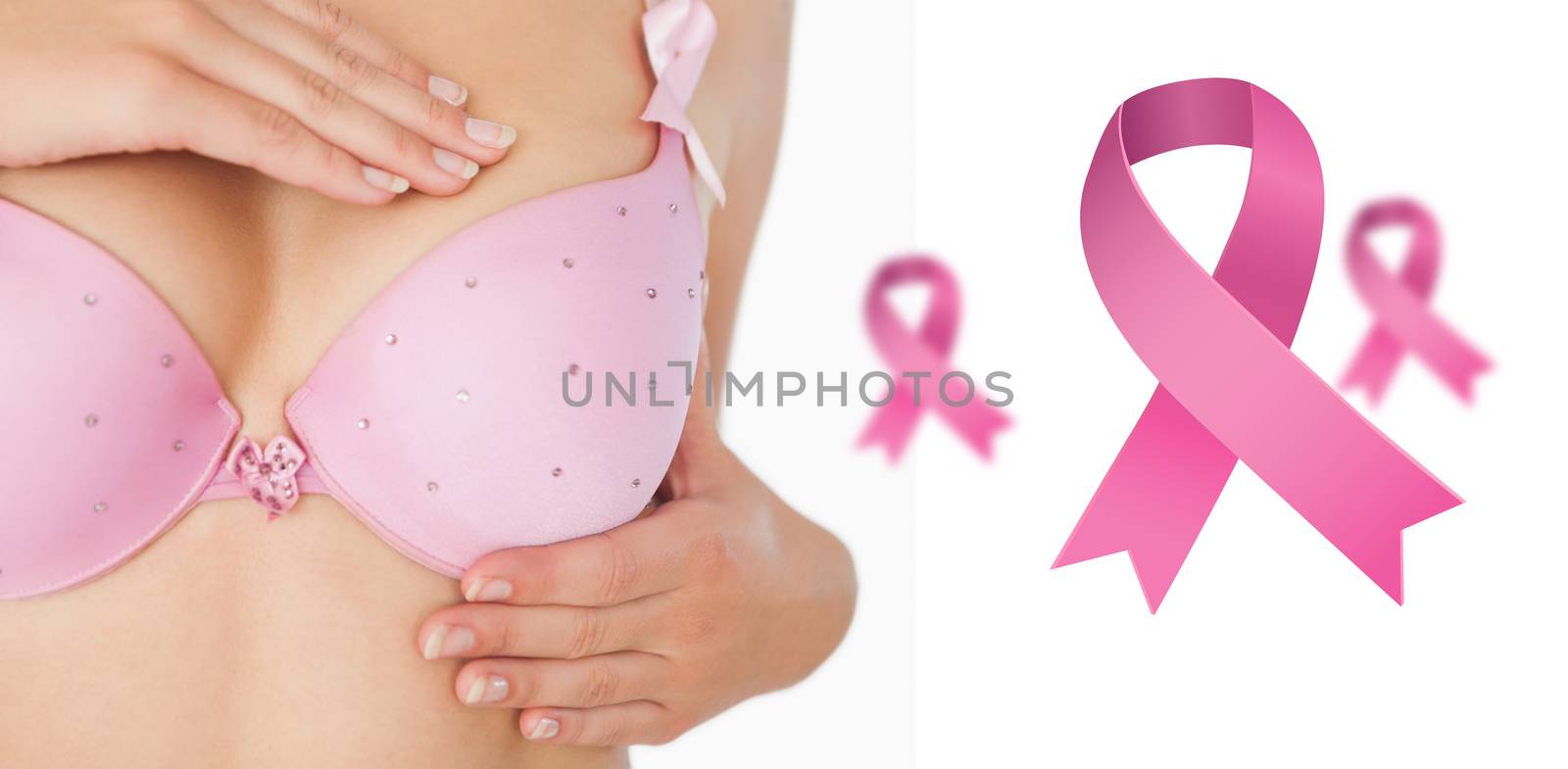 Closeup of woman performing self breast examination against pink breast cancer awareness ribbons