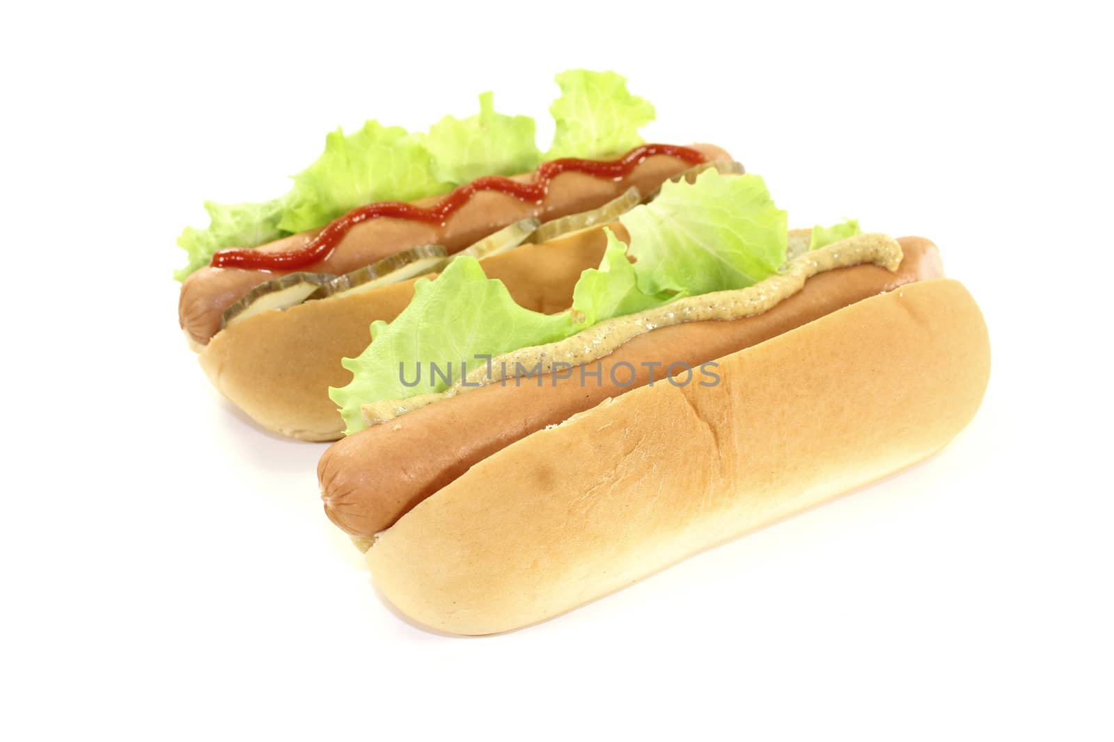 Hot dog with lettuce leaf, sausage, mustard and ketchup