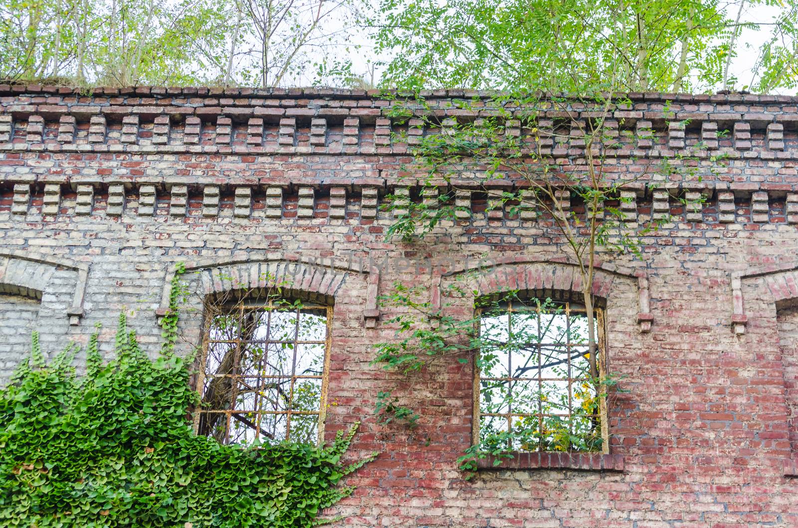 Abandoned factory building. Crumbling Collapsing brick wall, old mortar joints.