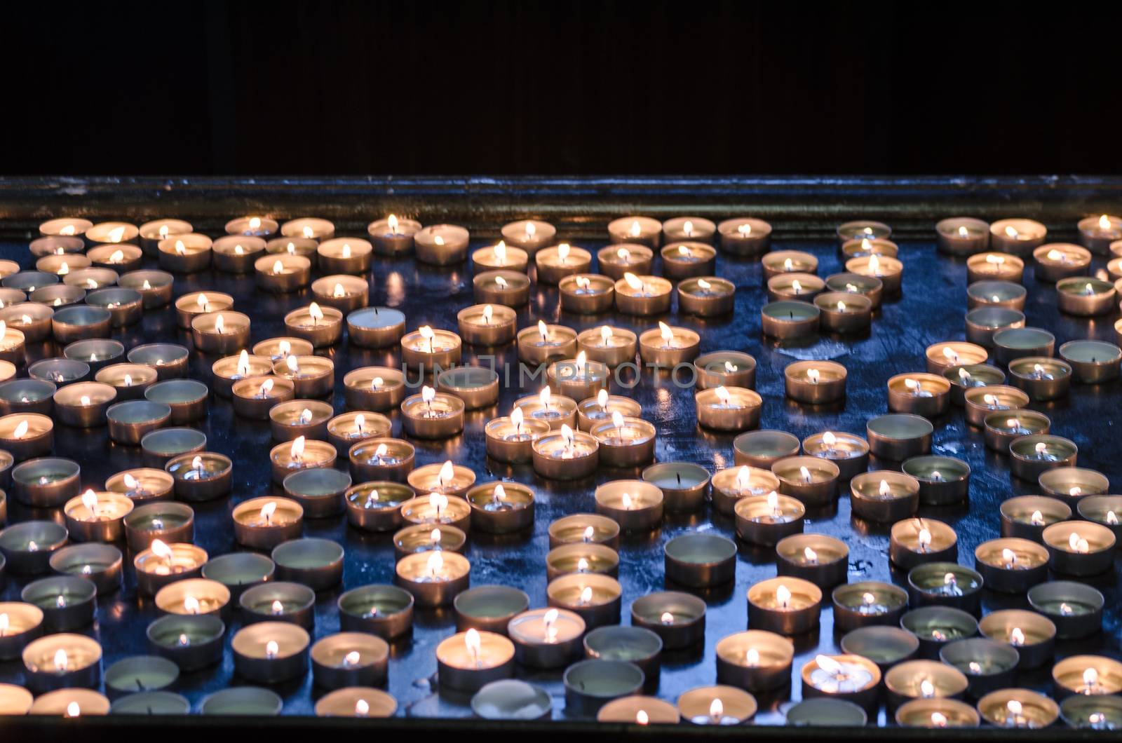 Candles donation in a church  in memory of the survivors. 