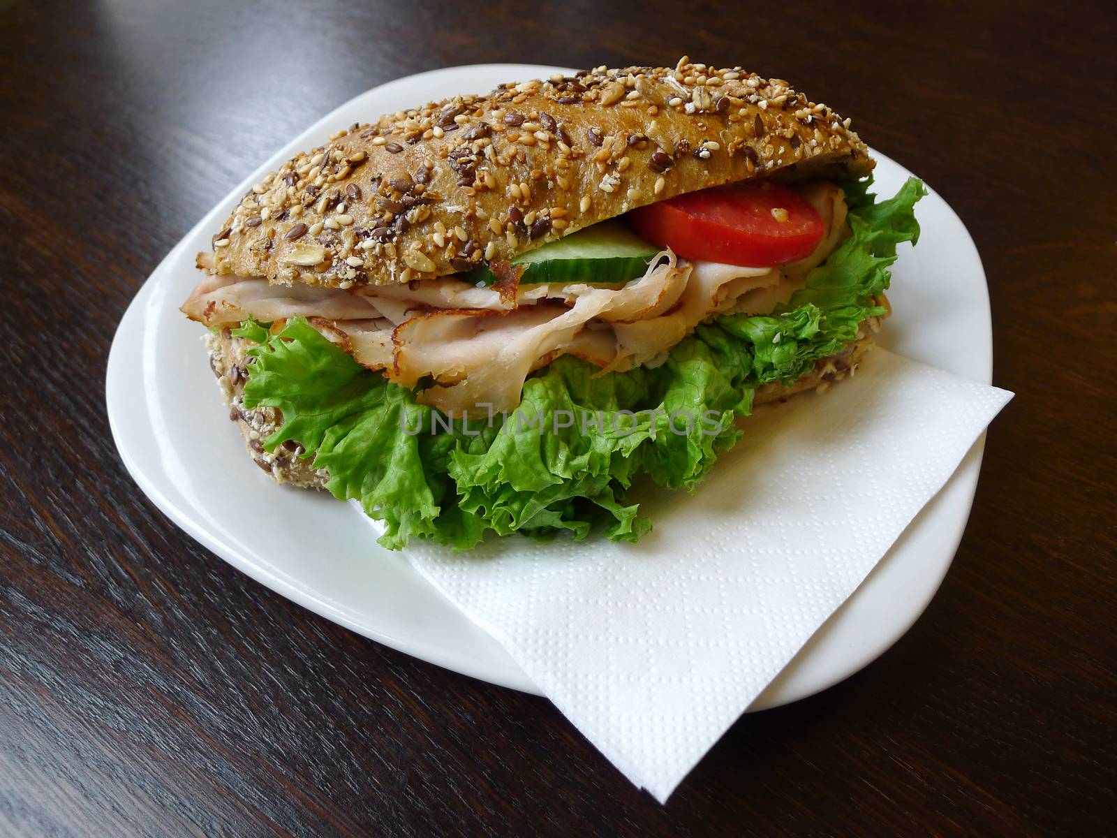 Delicious and fresh German sandwich close up on wooden fast food table.