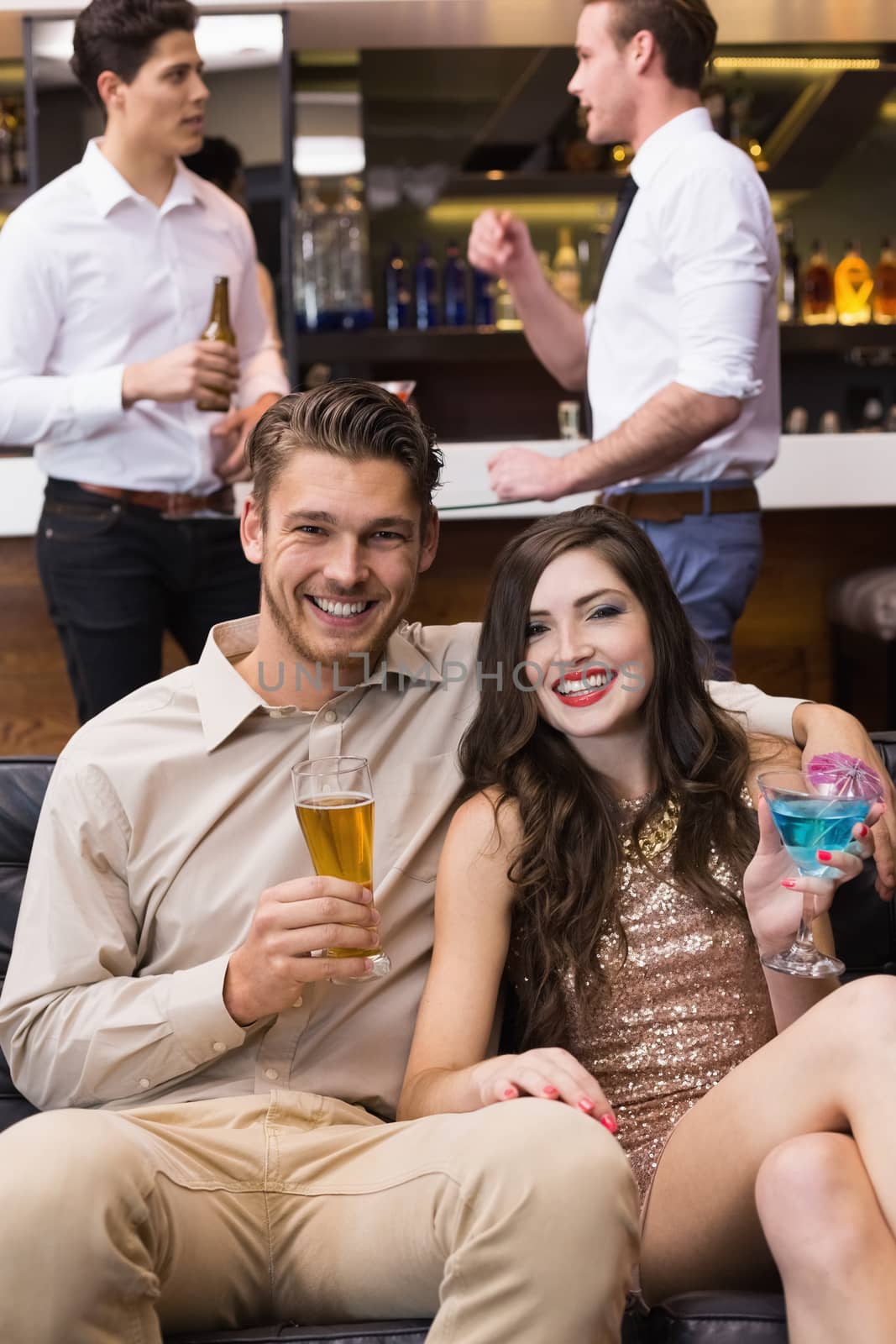 Happy couple having a drink together by Wavebreakmedia