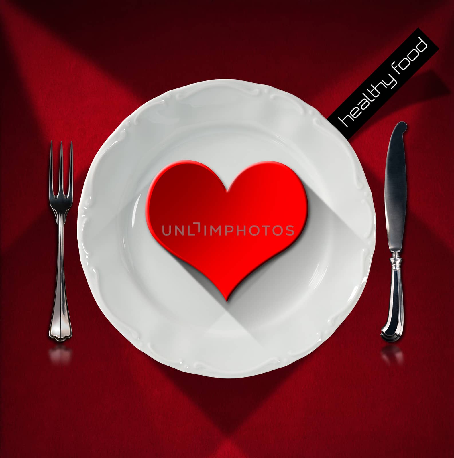 Red heart on the white plate with silver cutlery, fork and knife, on red velvet background with shadows. Concept of healthy food