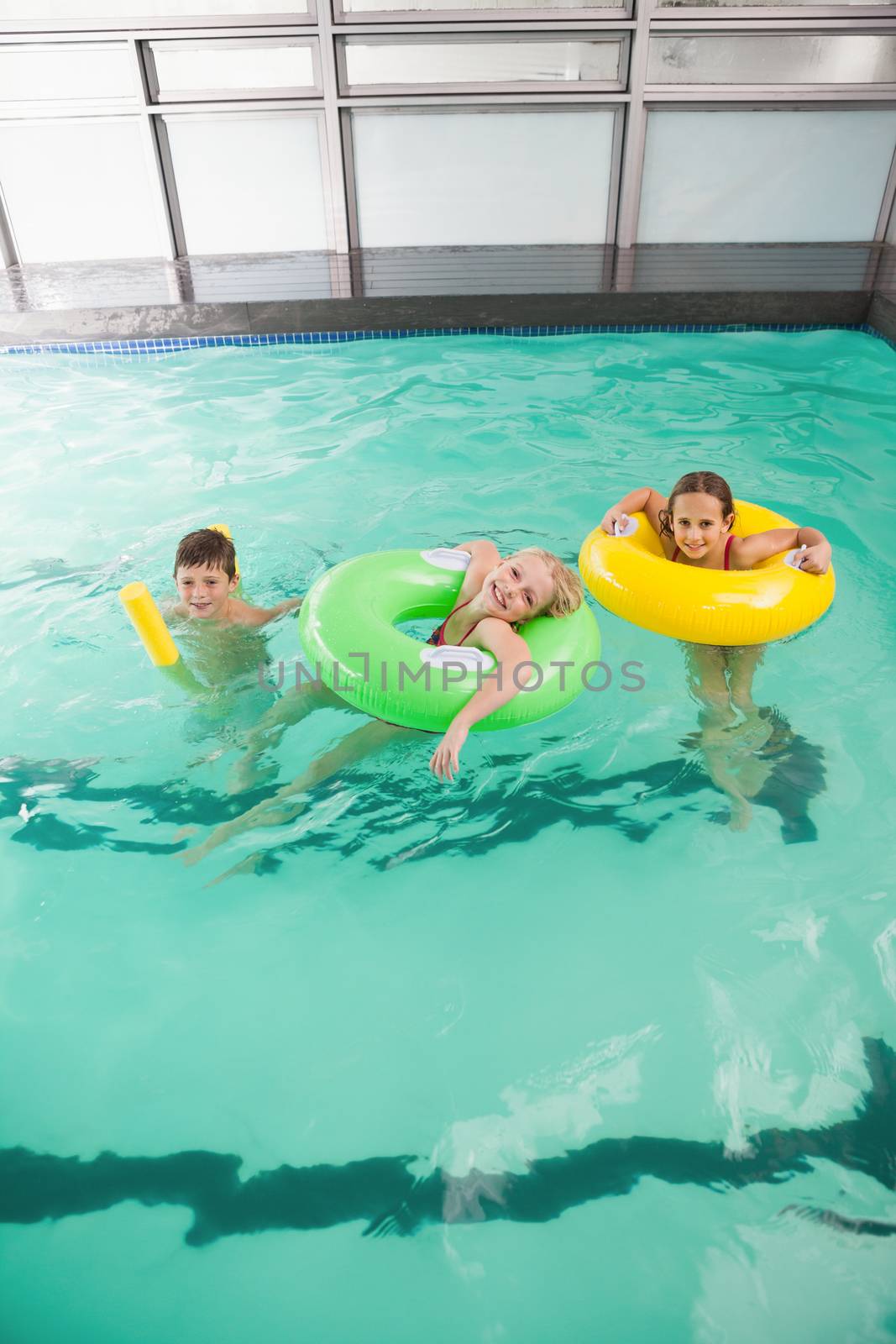 Cute little kids in the swimming pool at the leisure center