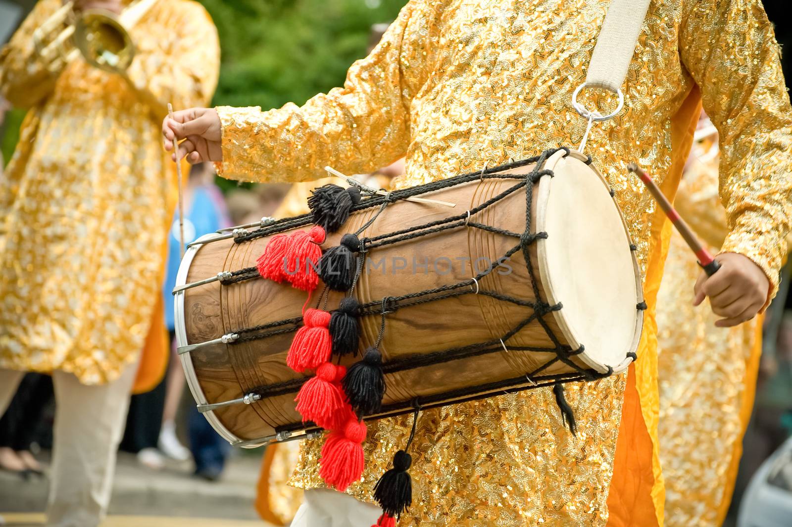 musician playing a traditional asian dhol drum