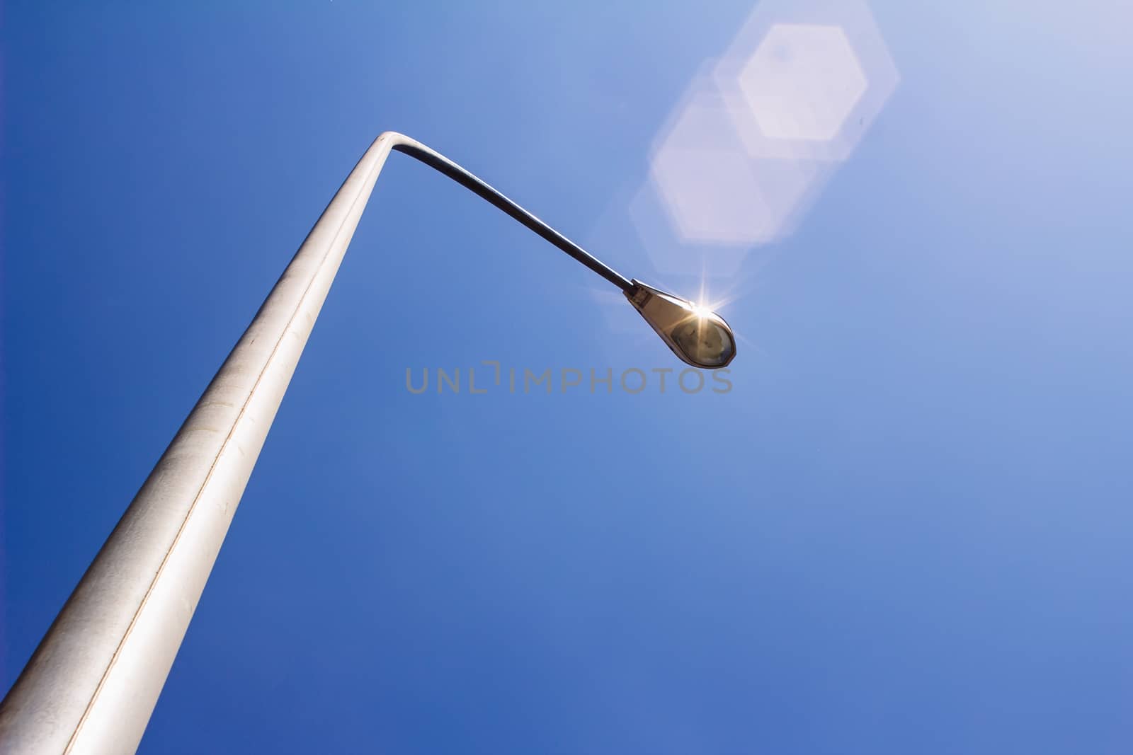 Street light is shining under the sunshine