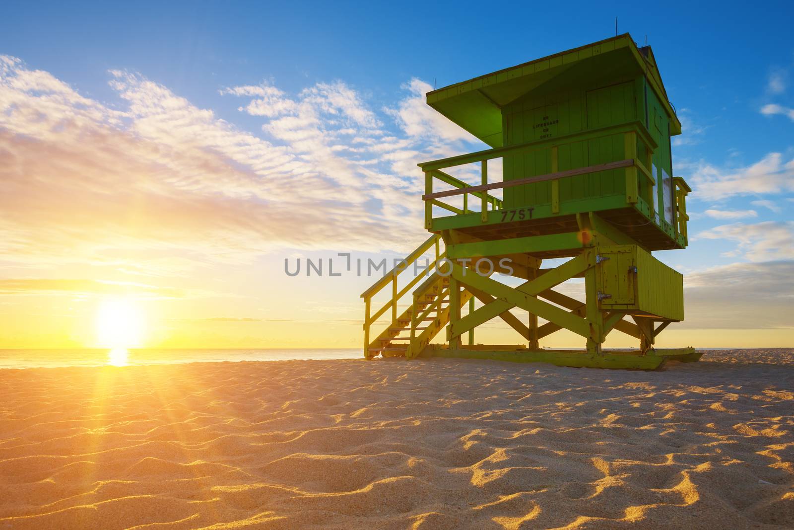 Miami South Beach sunrise with lifeguard tower and coastline, USA.