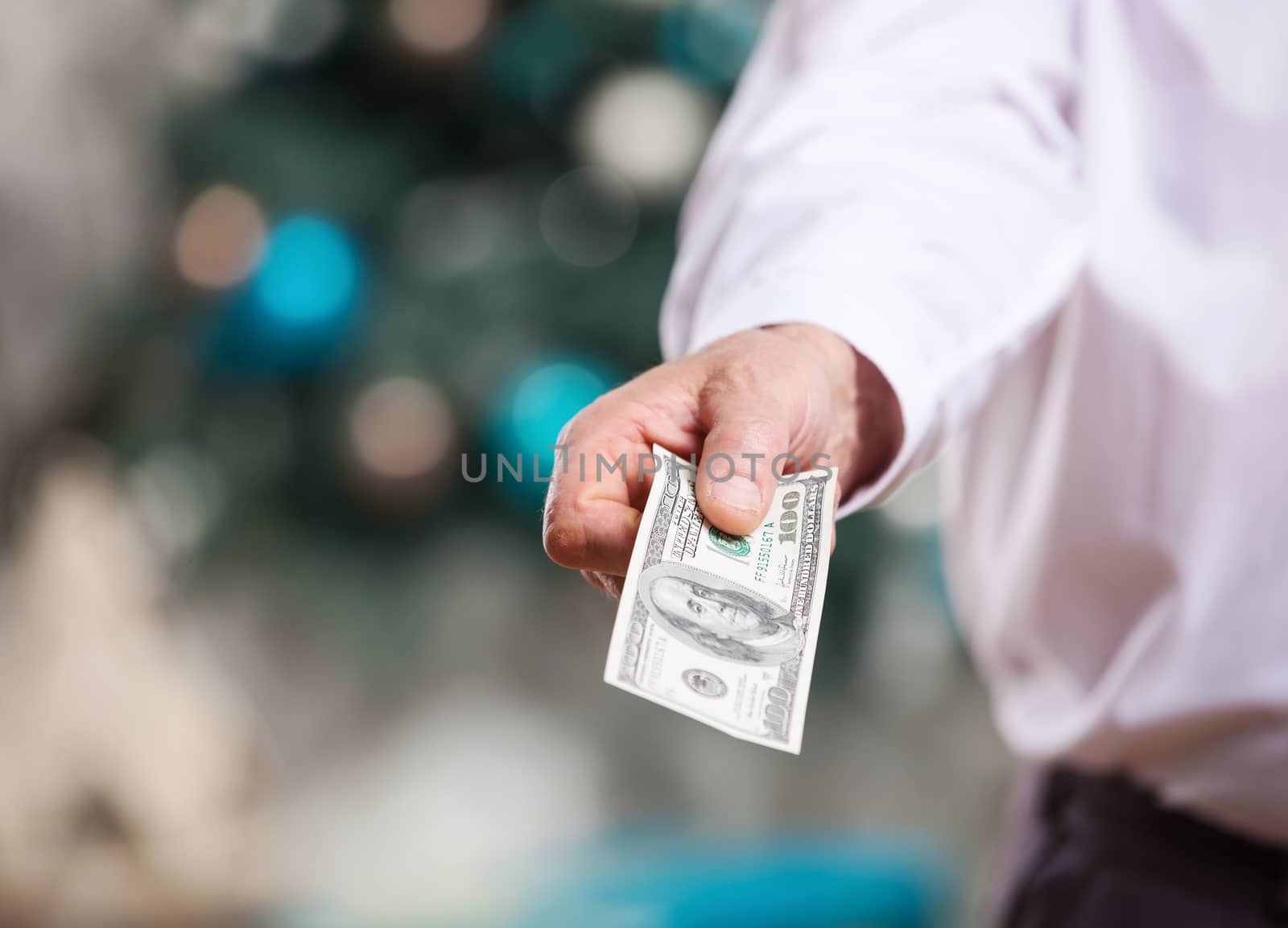 Hand with money on a Christmas background by photobac