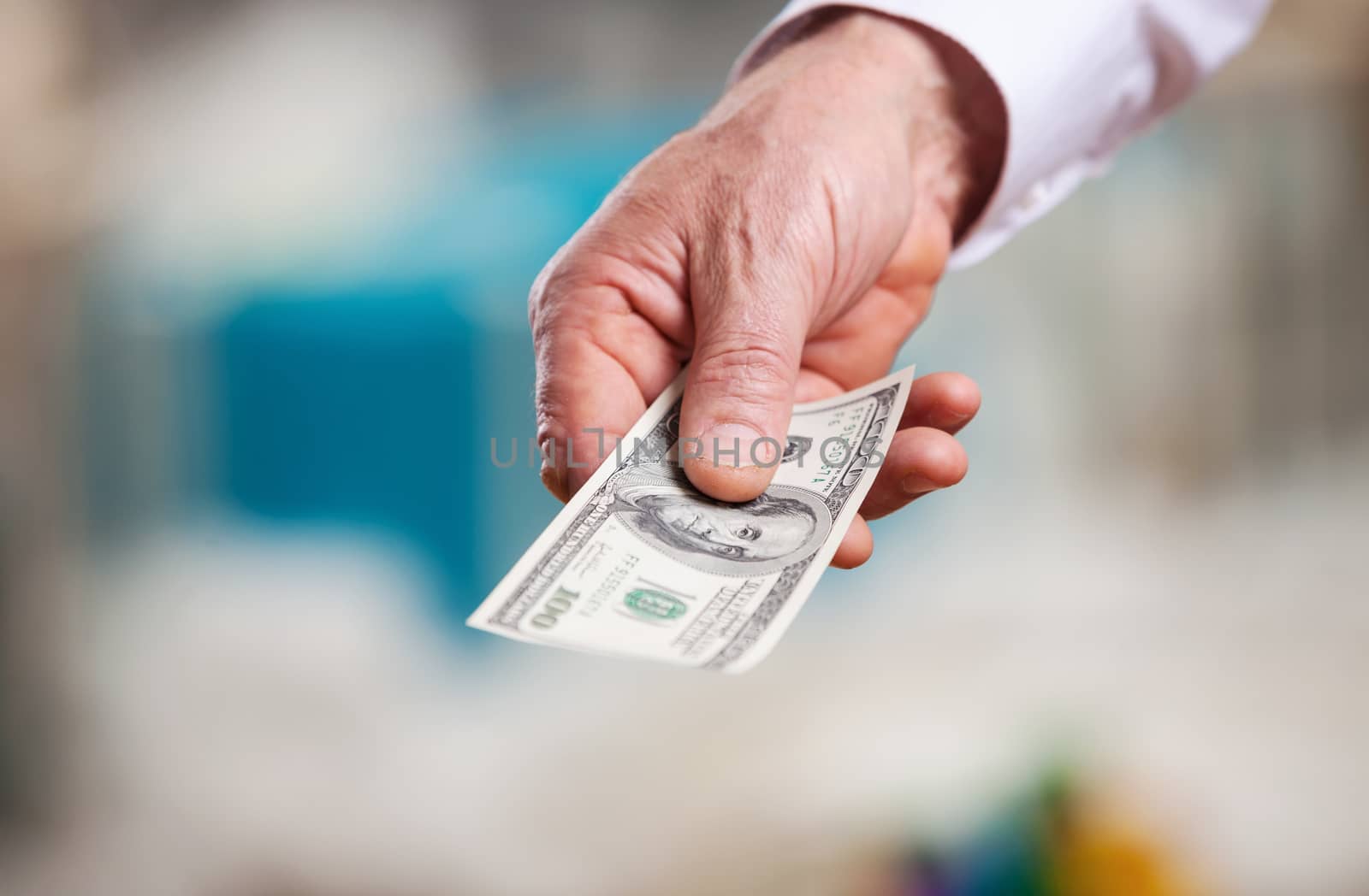 Male hand with money on a Christmas background