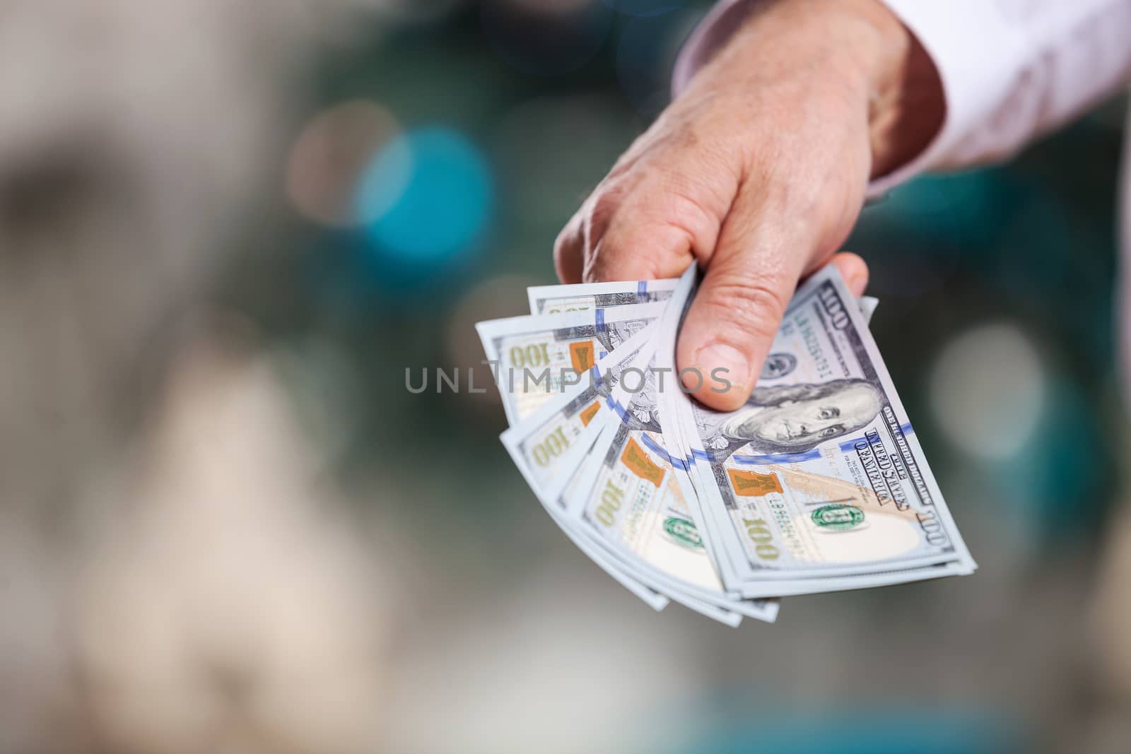 Hand with money on a Christmas background by photobac