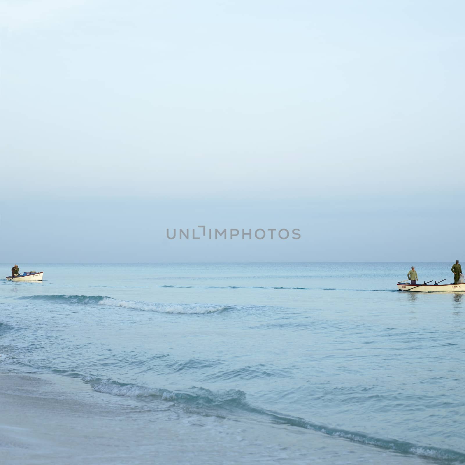 Men on boats on the tropical ocean