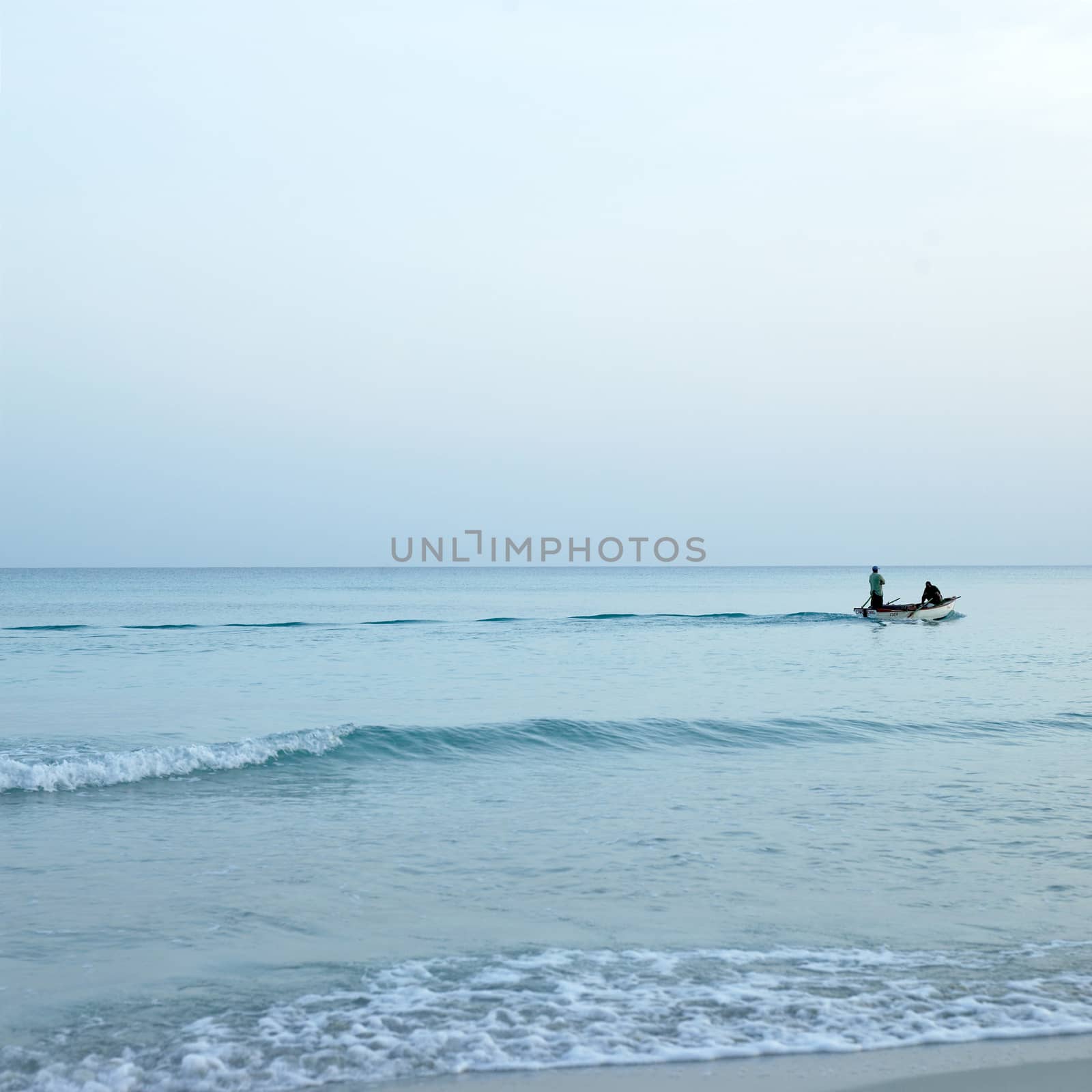 Men on boats on the tropical ocean