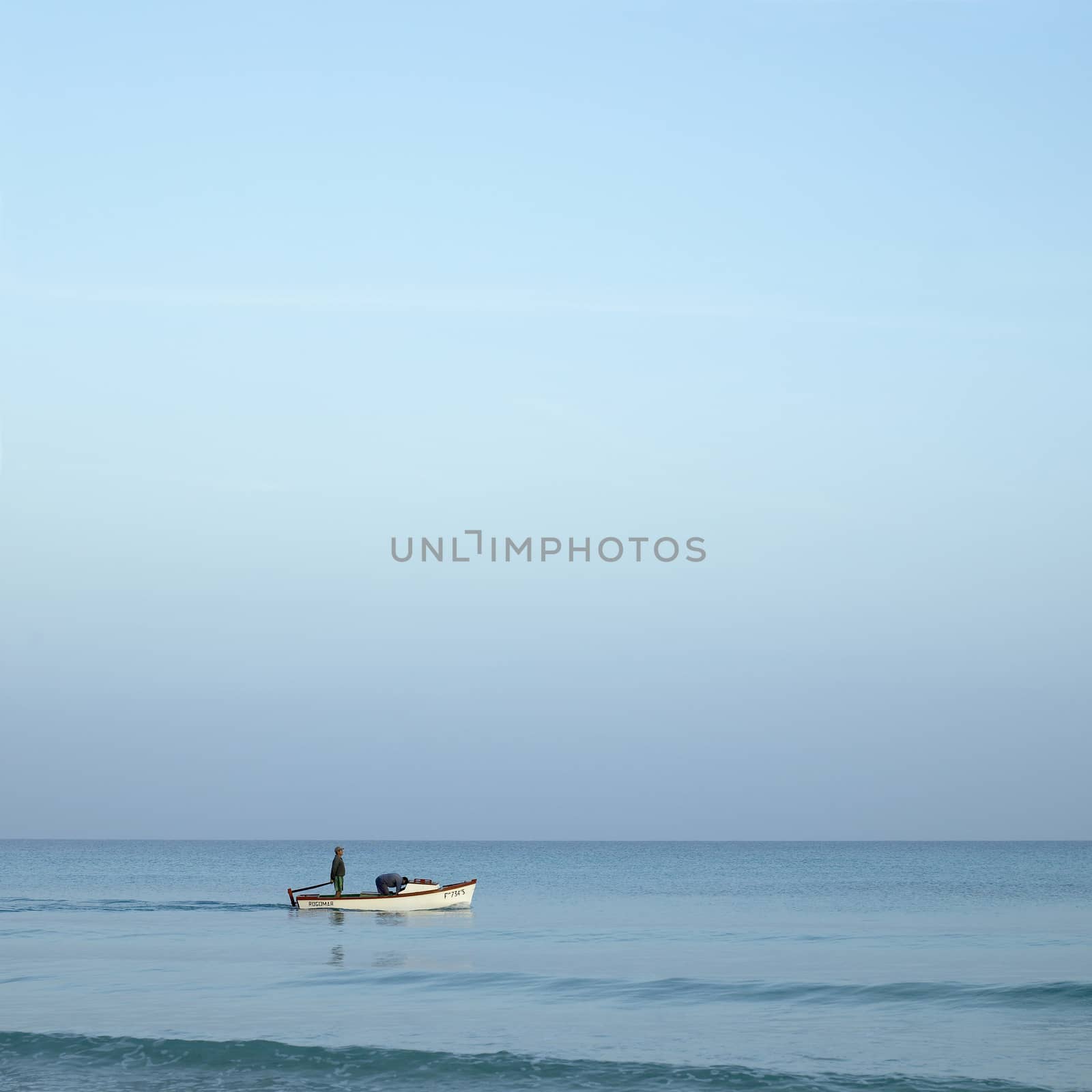 Men on boats on the tropical ocean