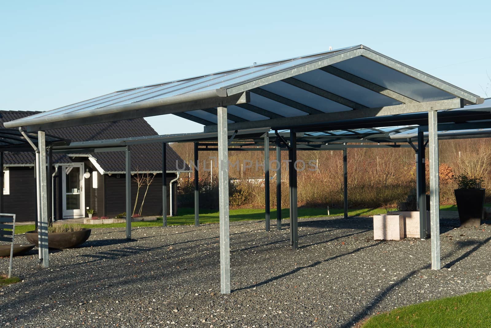 Modern carport car garage parking made from black metal and glass                                       