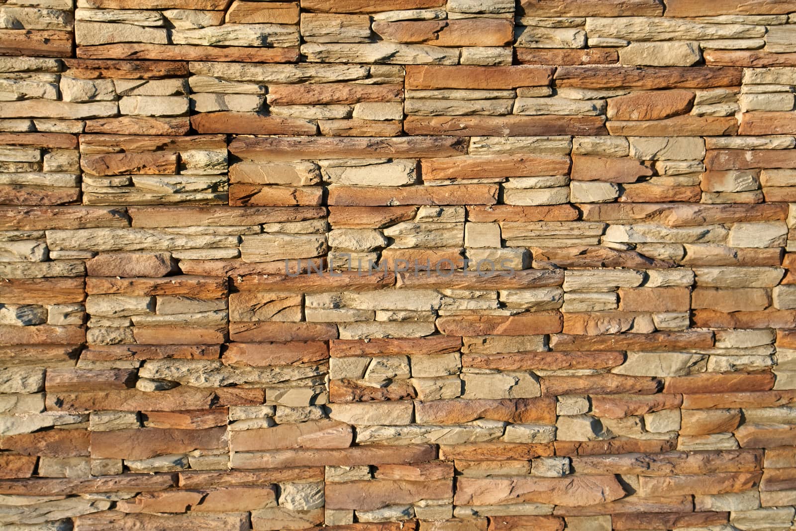 Brown shades color decorative design uneven stone stucco wall                               