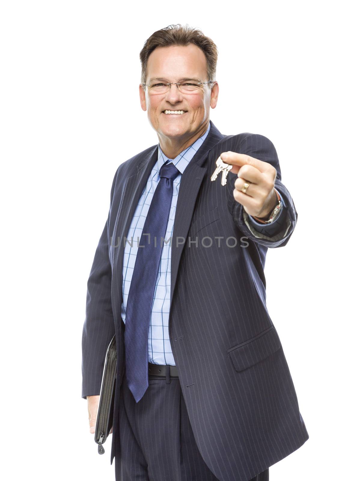 Handsome Real Estate Agent Holding Out Keys to New Home Isolated on a White Background.