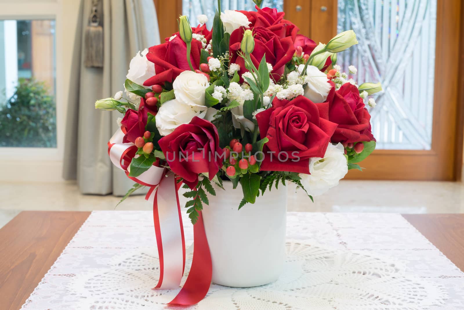 Roses flowers bouquet inside vase on desk in house for decoration