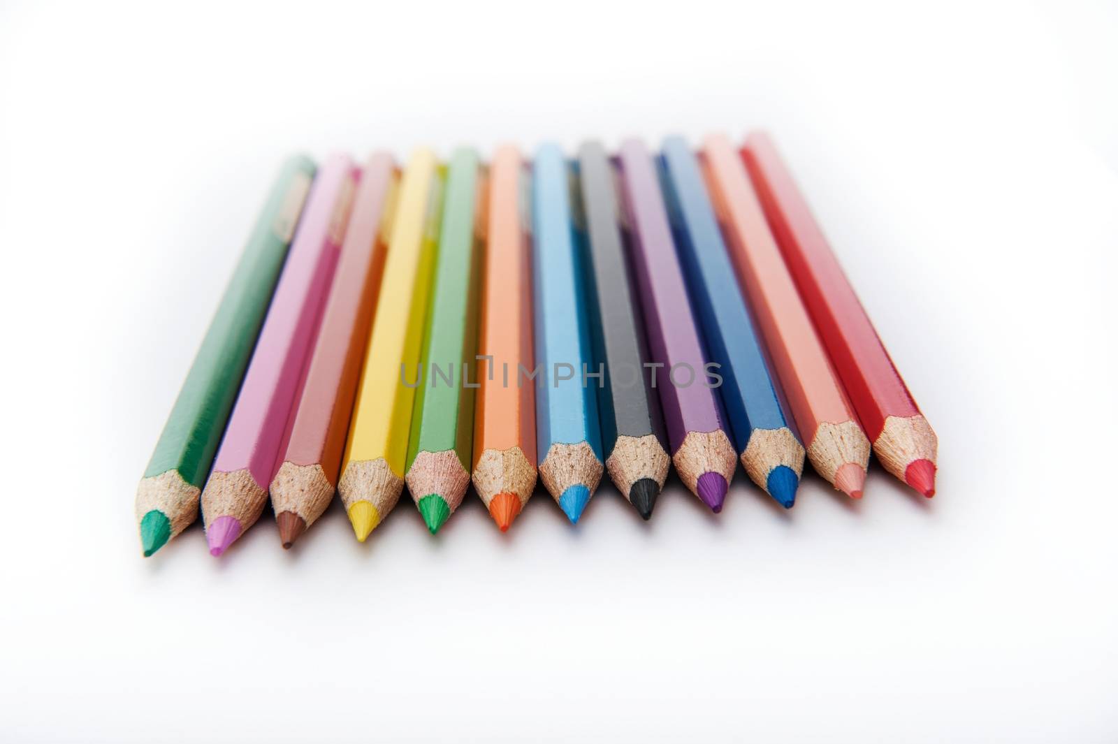 Isolated on the white background horizontal shot of angled set of 12 colored pencils