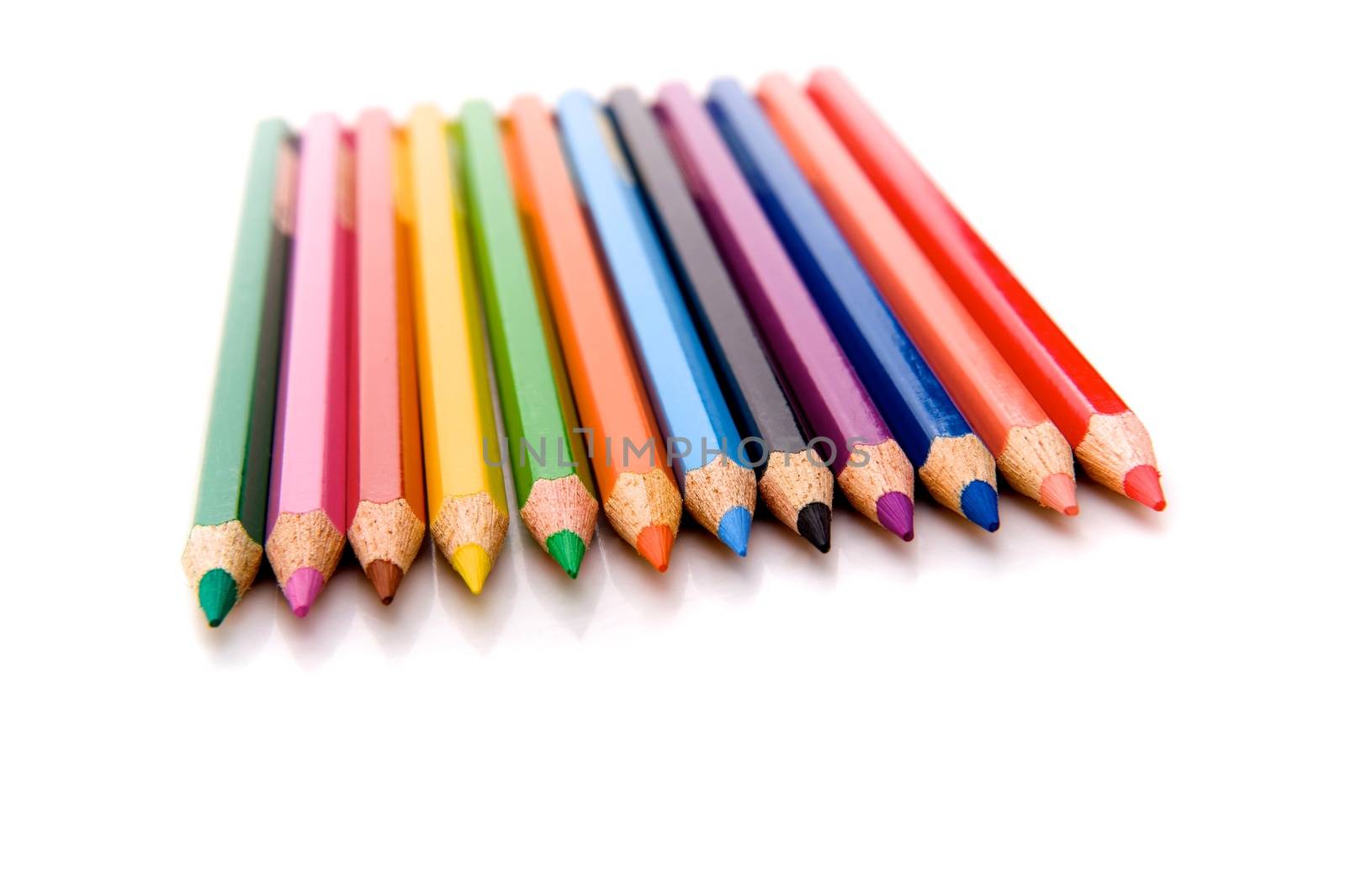 Isolated on the white background horizontal shot of twelve sloped colored pencils