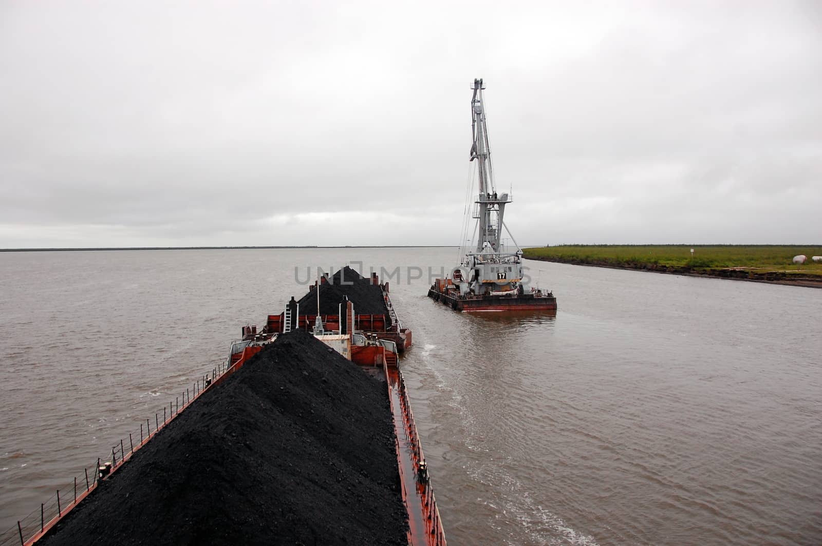 Ship with coal and crane at Kolyma river by danemo