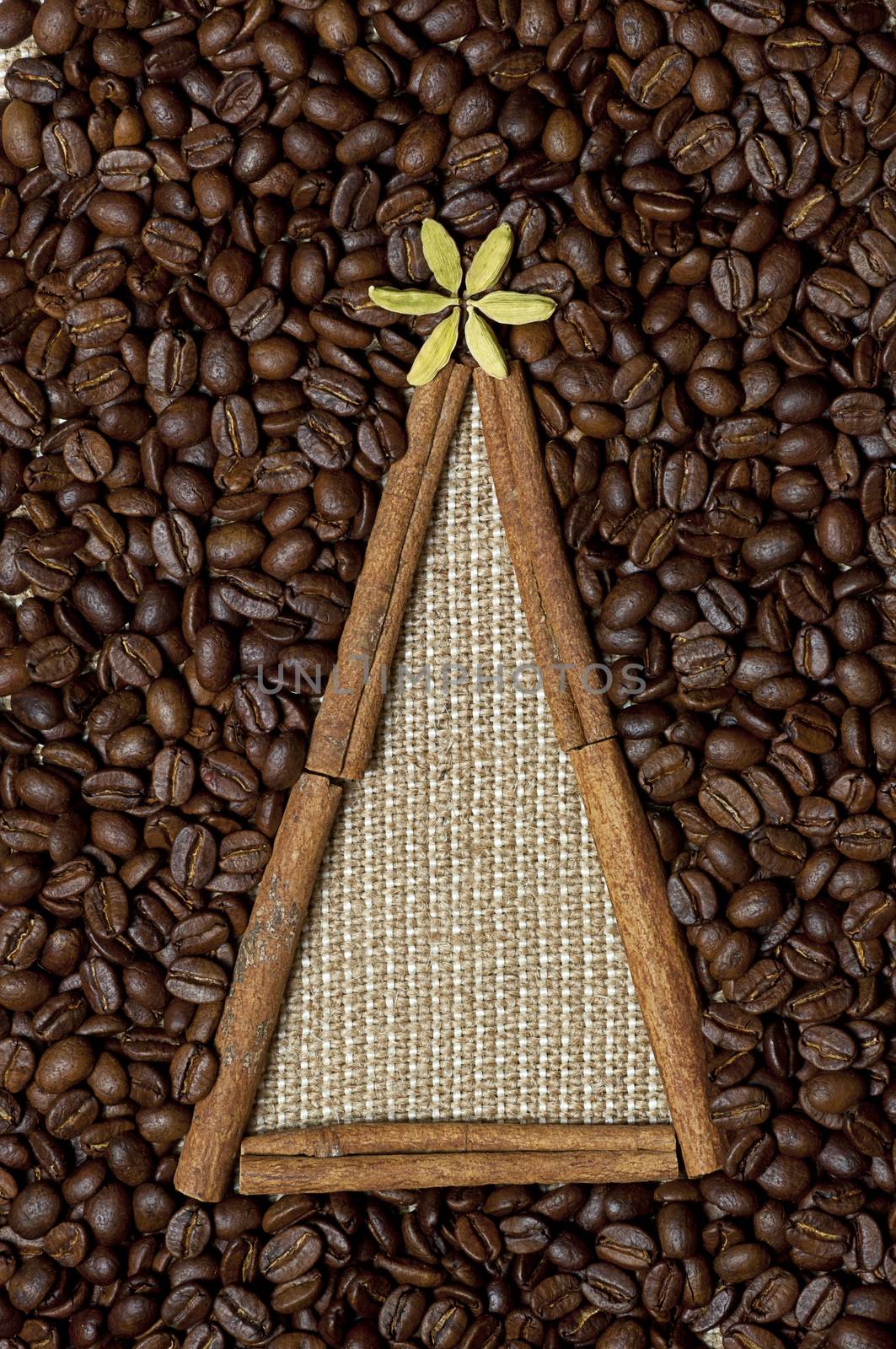 Christmas tree made of cinnamon sticks on coffee and sack background