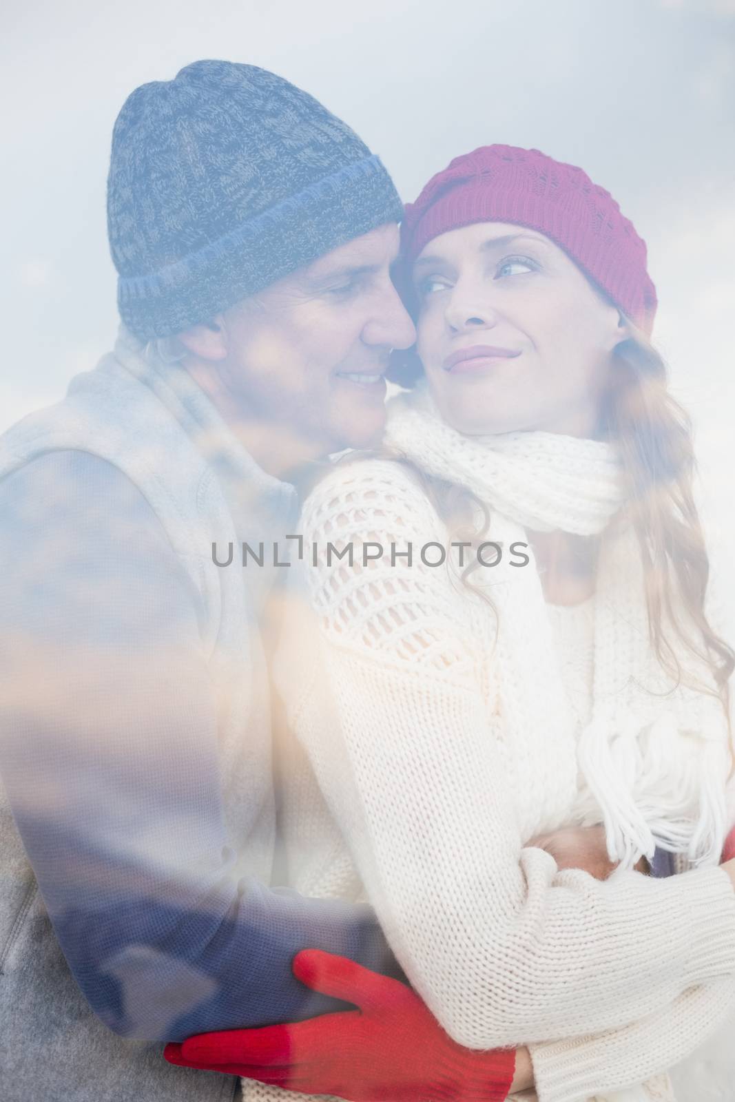 Happy couple in warm clothing seen through glass window