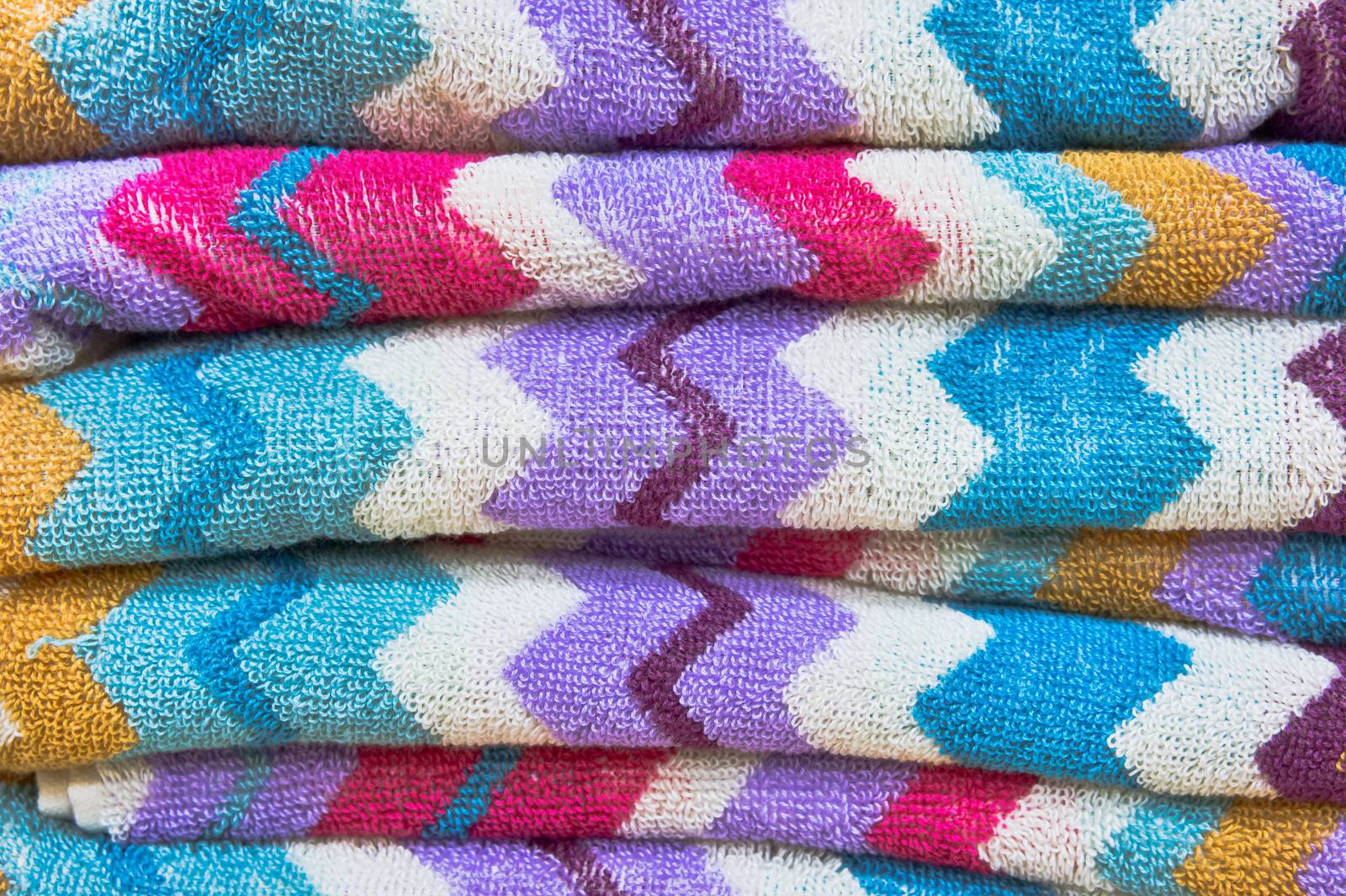 Stack of vibrant new towels as a background