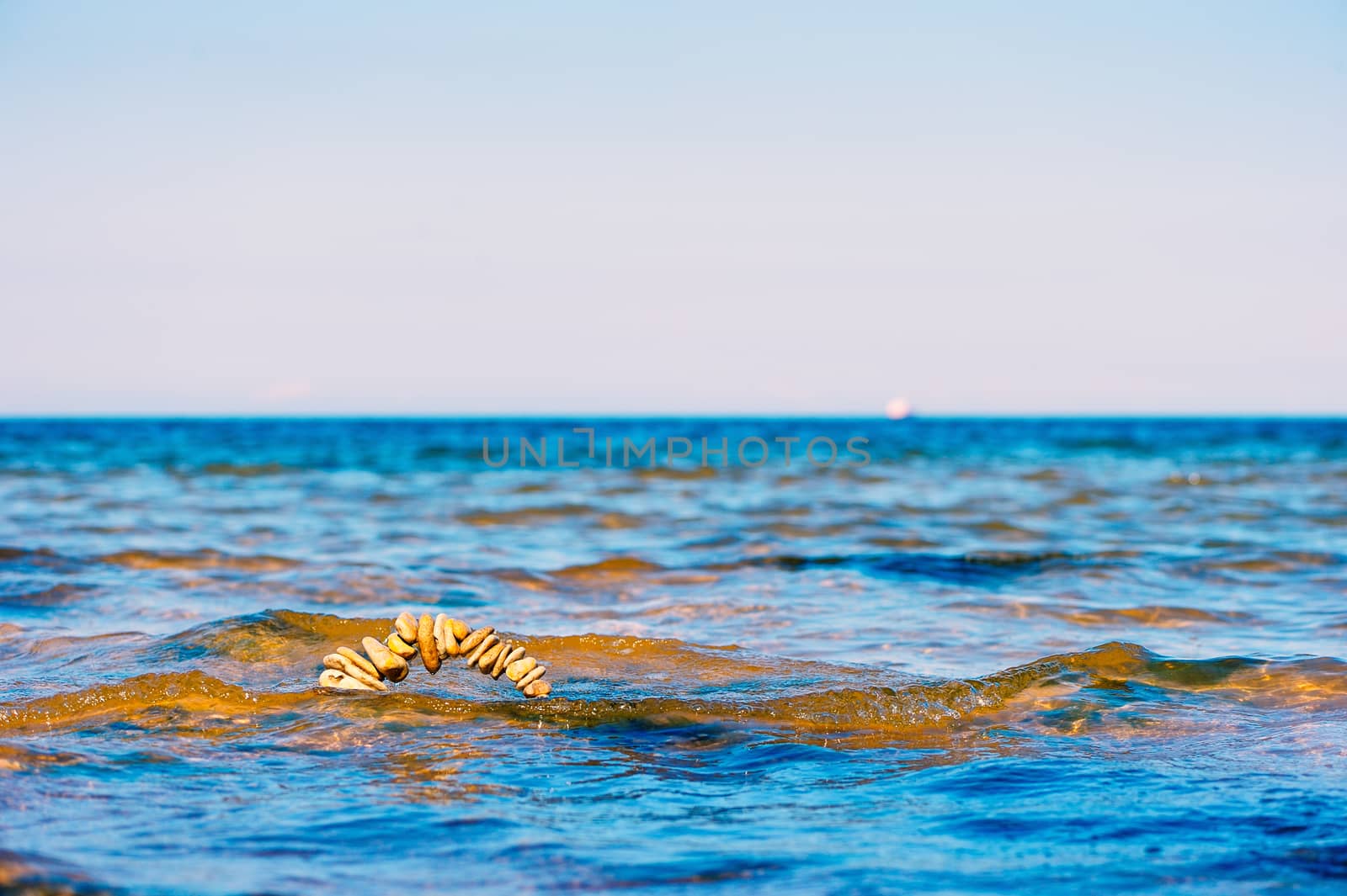 Circle of pebbles on the surface of the sea