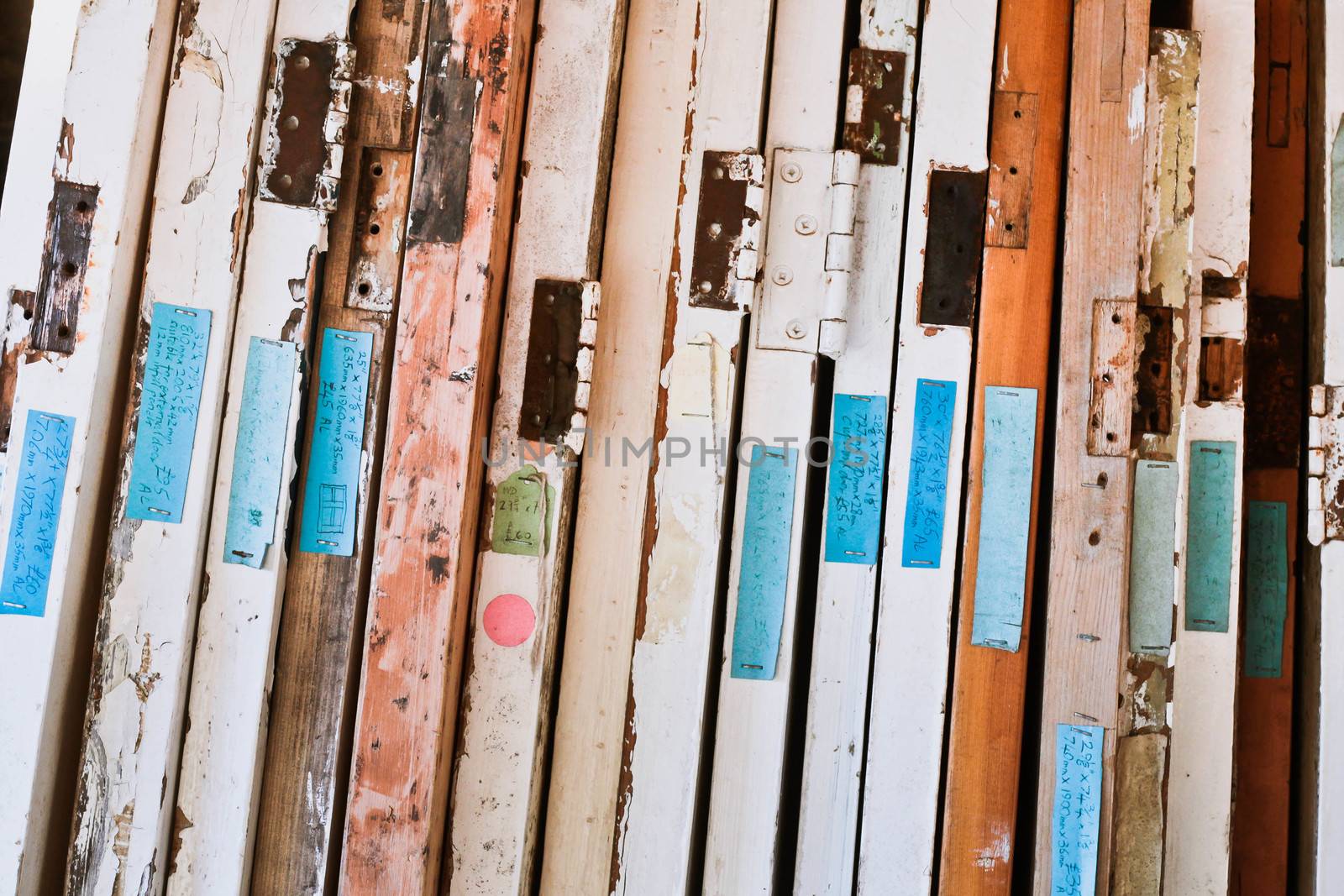 Ends of old wooden doors with hinges