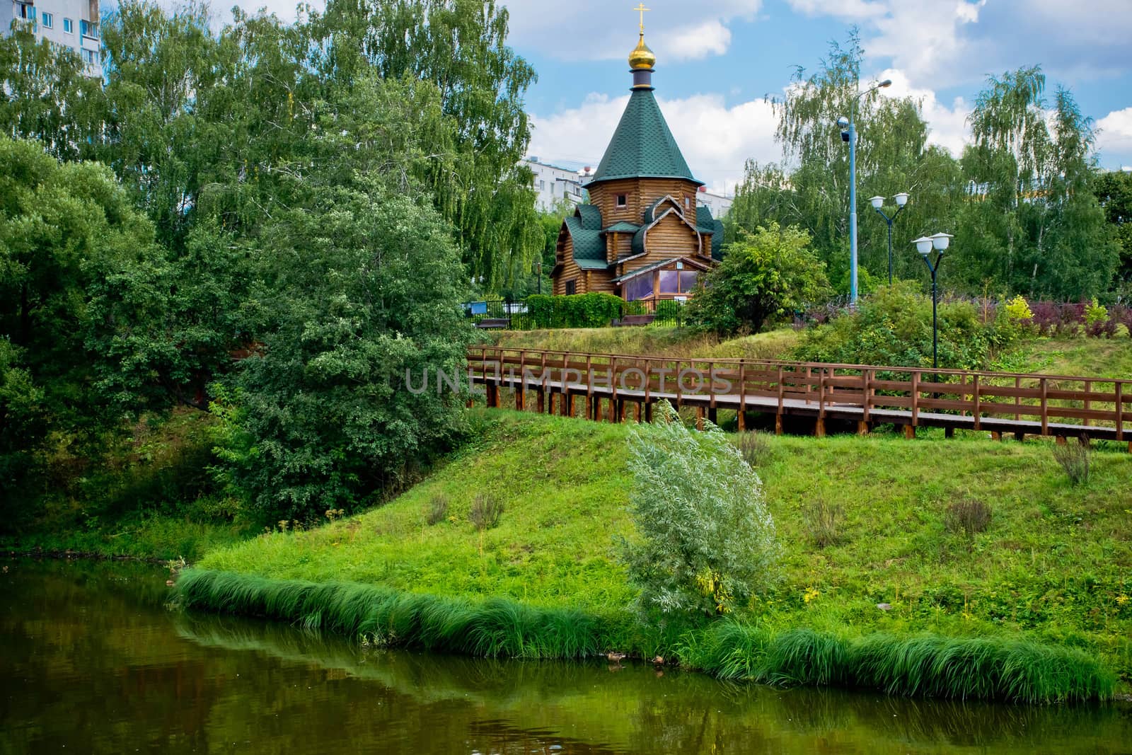 wooden chapel on the shore of a calm river