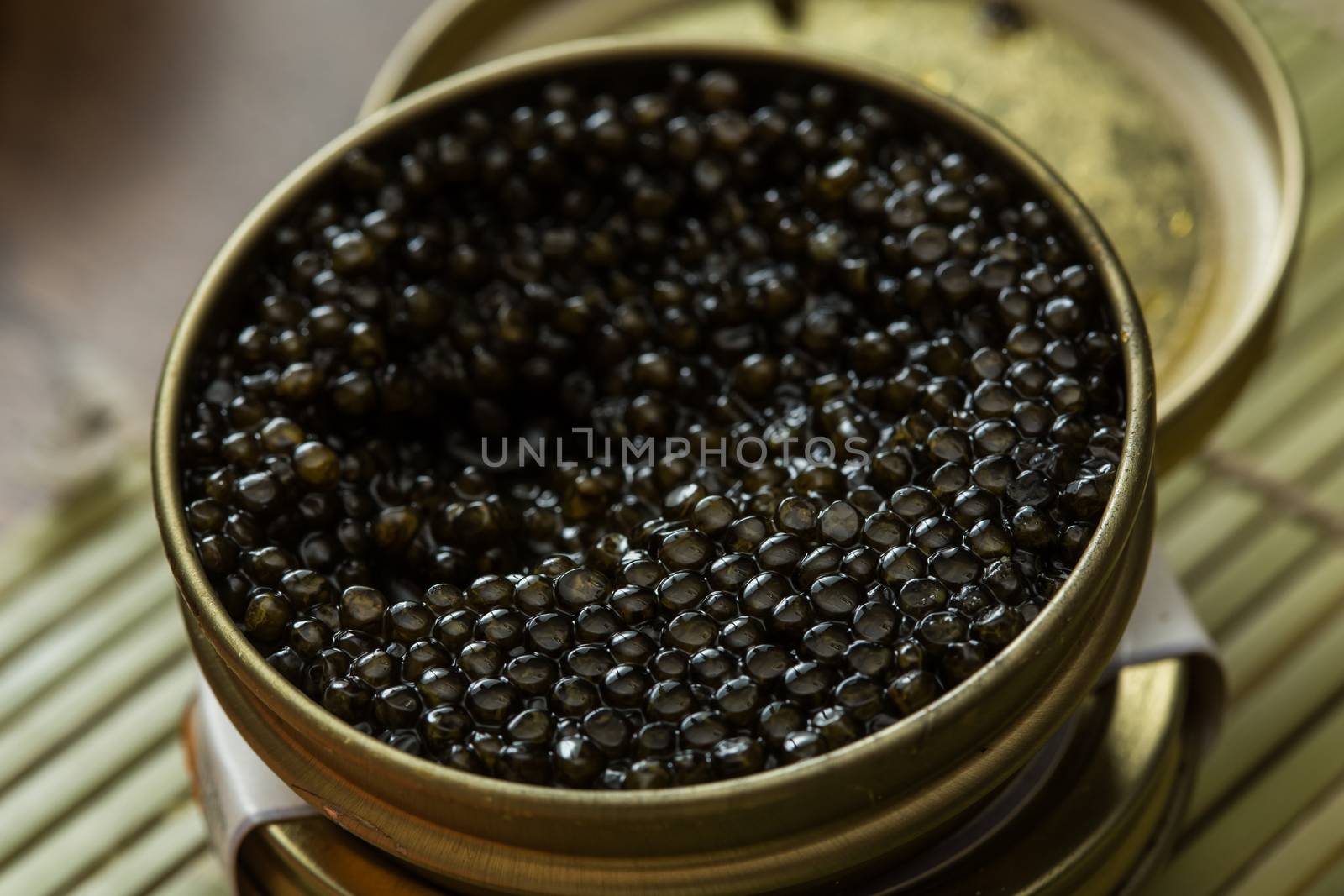 Black caviar in small round metal tin on ice