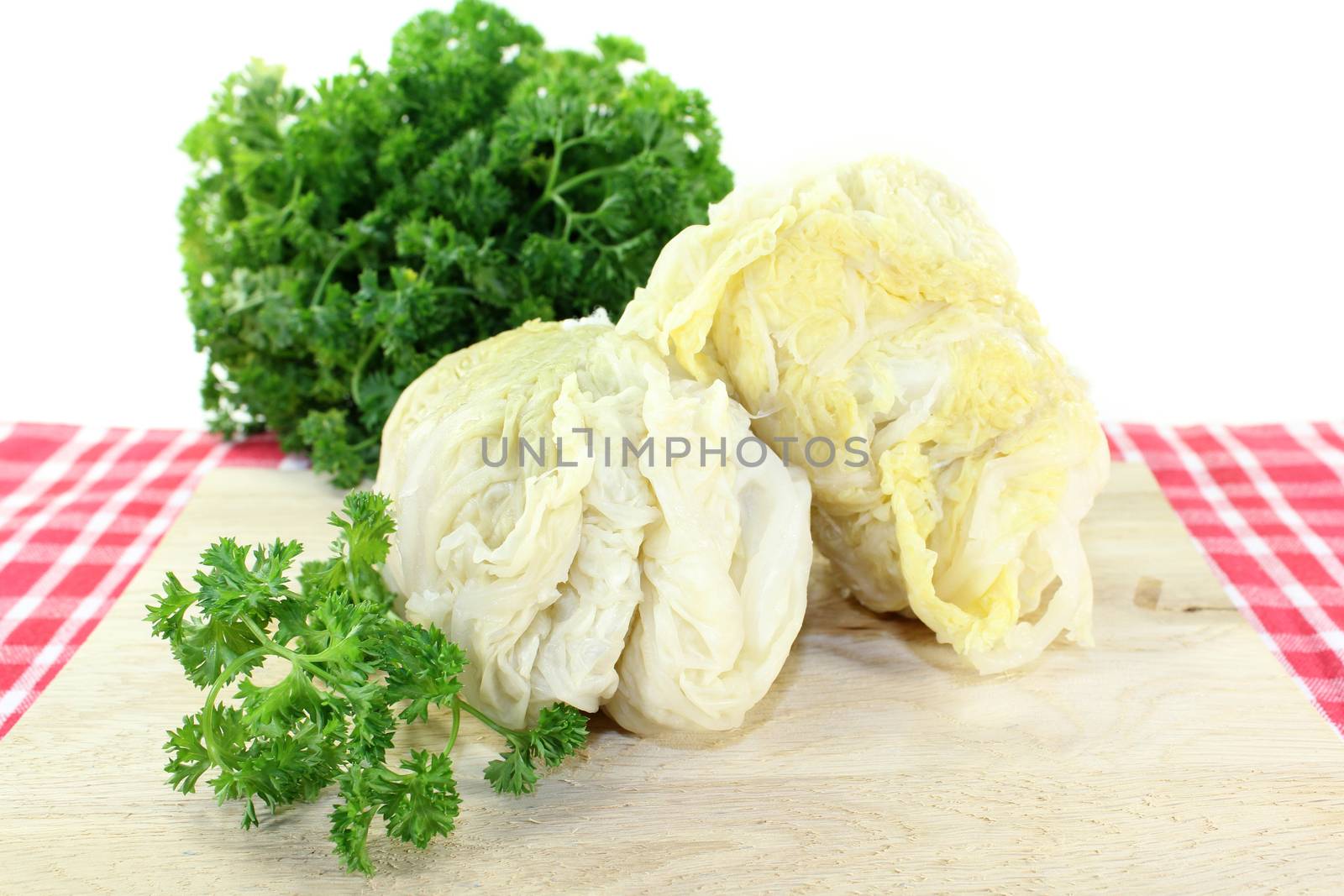 Savoy cabbage roulade with parsley against white background