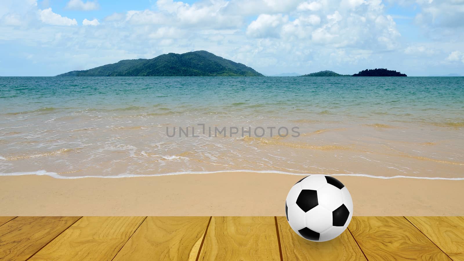 Football at the beach with island background