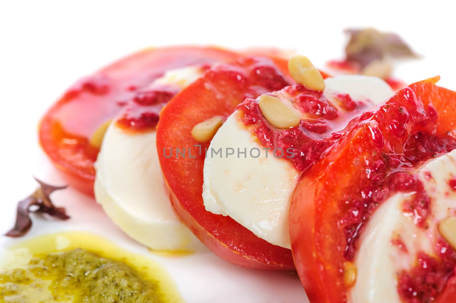 Caprese antipasto salad with mozarella cheese, tomatoes, isolated on white