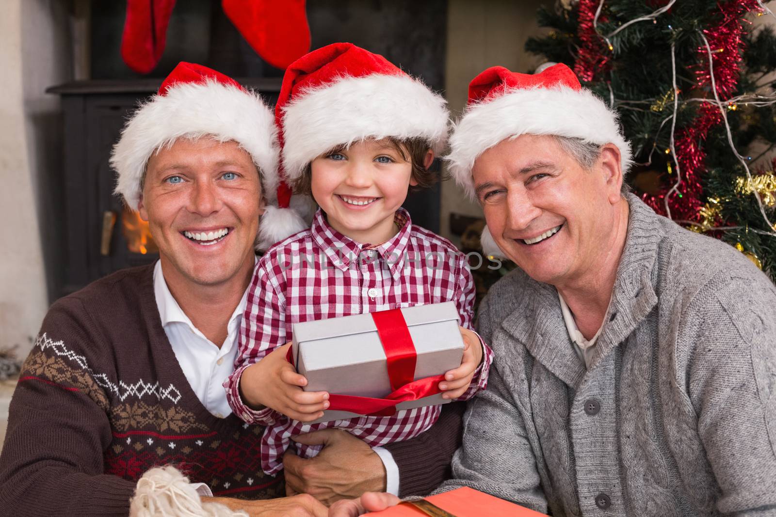 Three generation family celebrating christmas at home in the living room