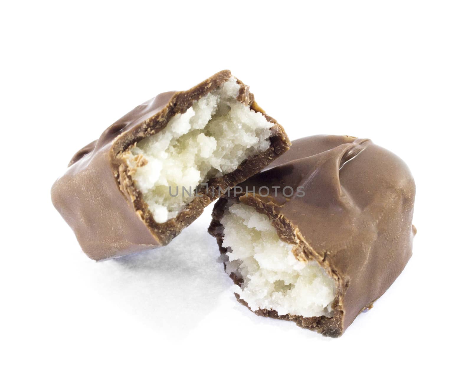 Closeup of chocolate bar with coconuts isolated on white.