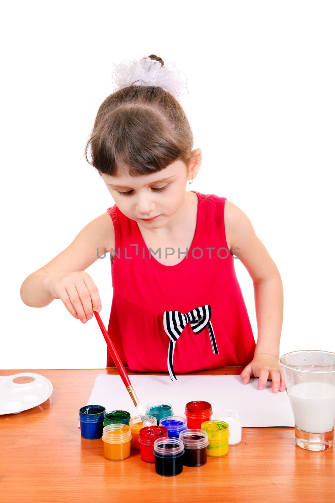 Concentrated Little Girl Drawing Isolated on the white background